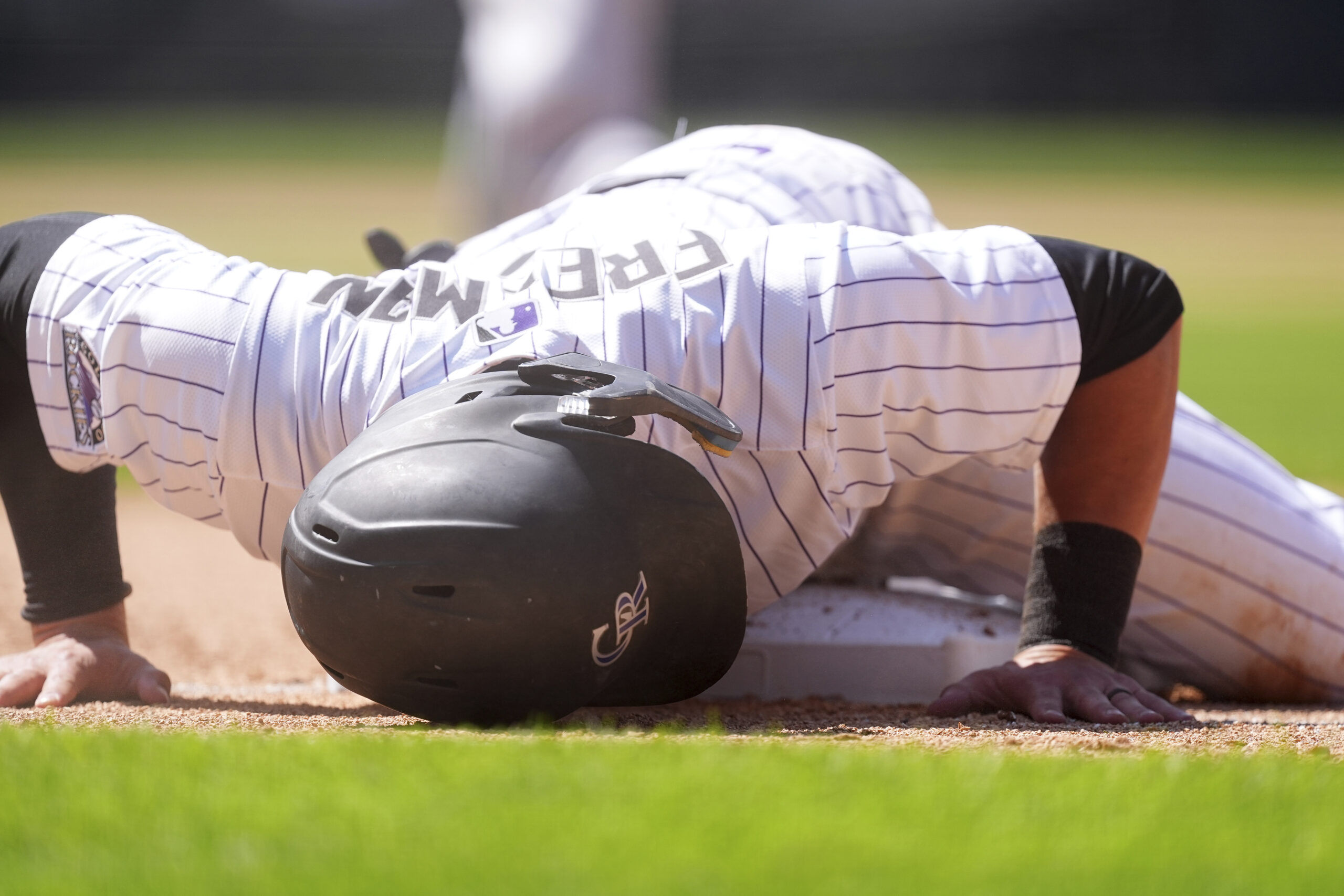 The Colorado Rockies’ Tyler Freeman reacts after being caught off...