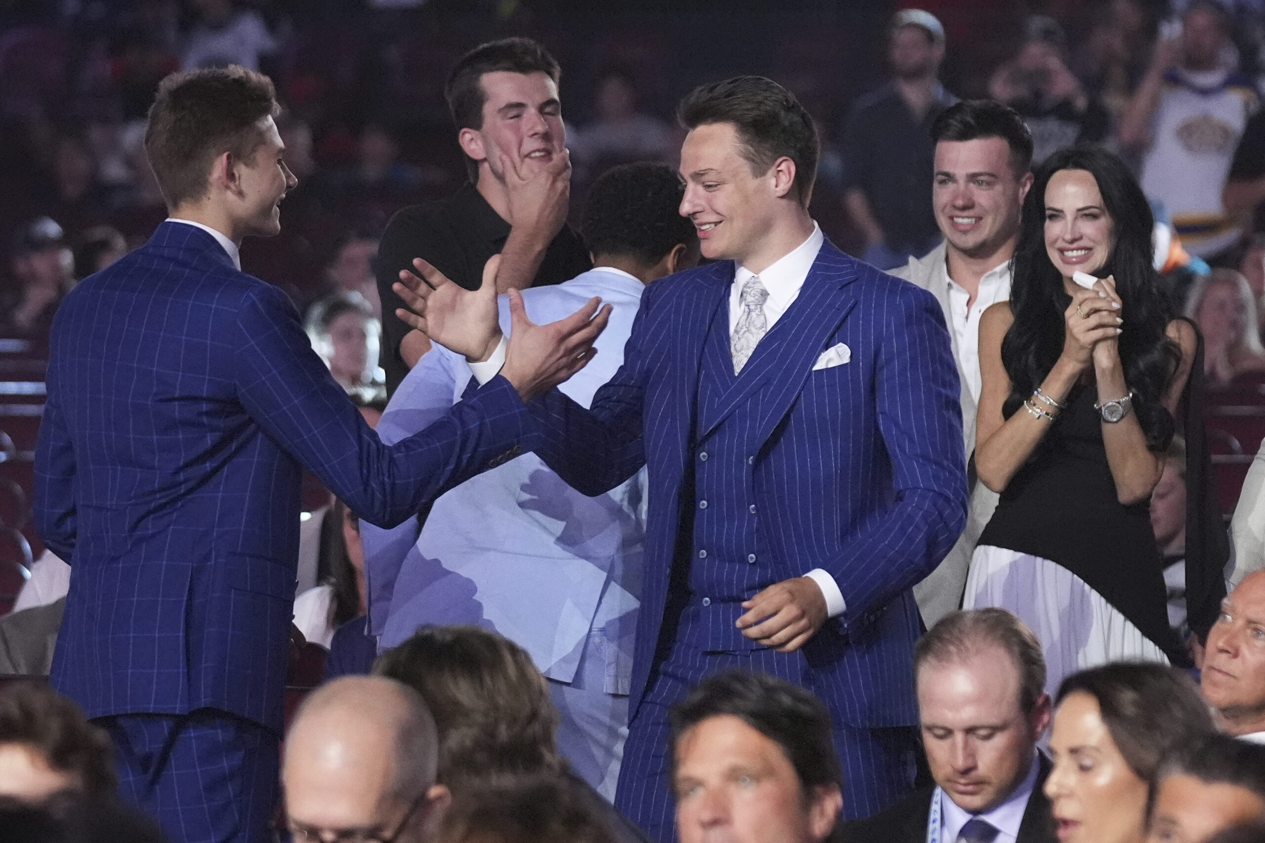 Prospect Henry Brzustewicz, middle, is congratulated after being drafted by...