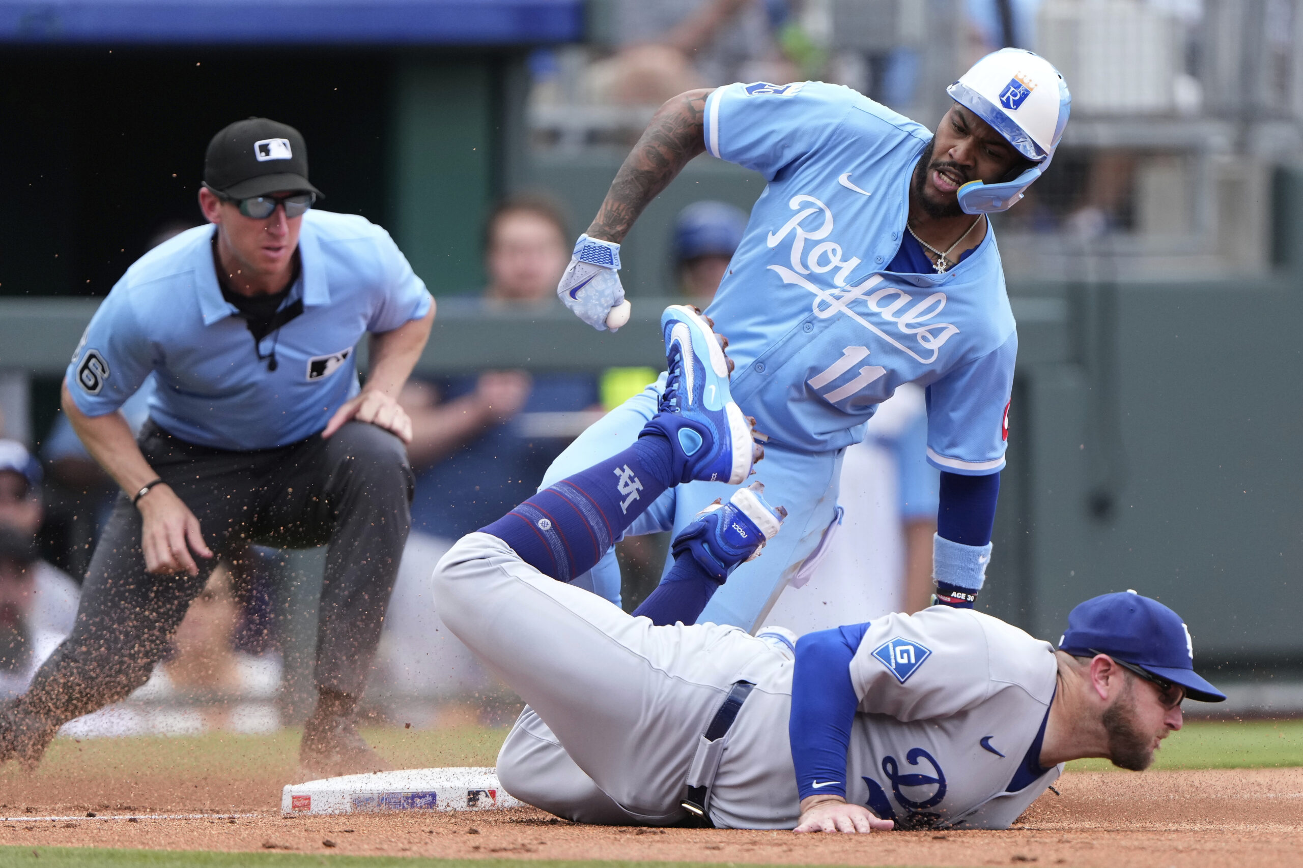 Kansas City Royals’ Maikel Garcia (11) beats the tag by...