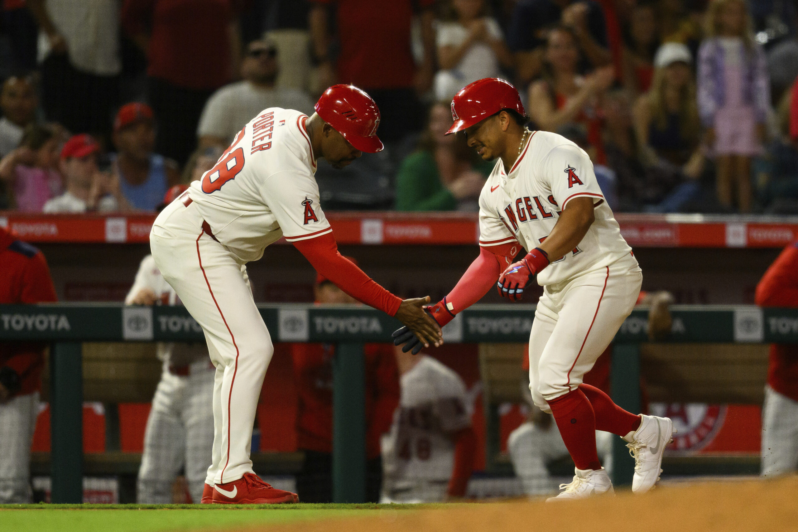 Angels’ Gustavo Campero, right, celebrates with third base coach Bo...