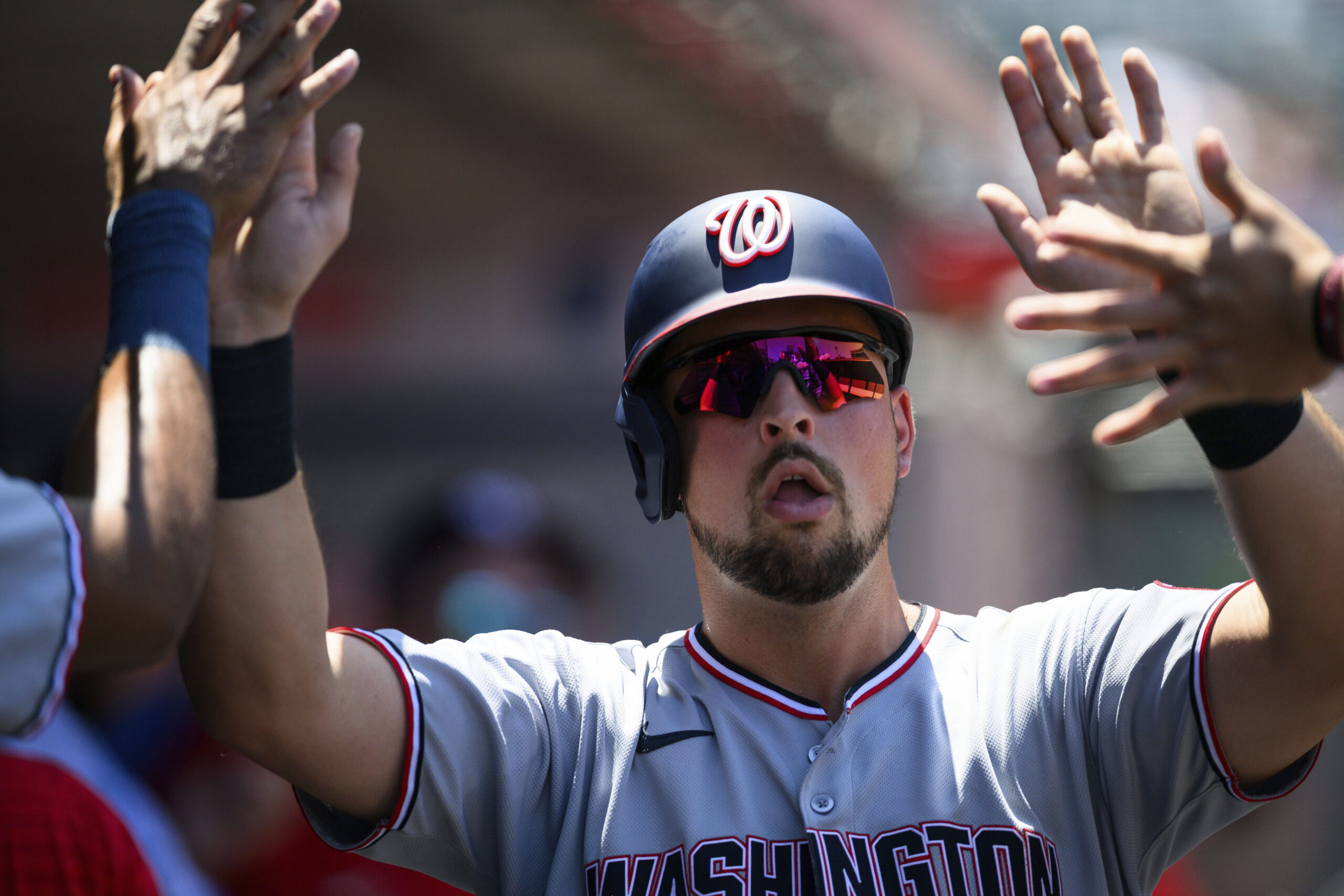 Washington Nationals’ Nathaniel Lowe is greeted by teammates after scoring...