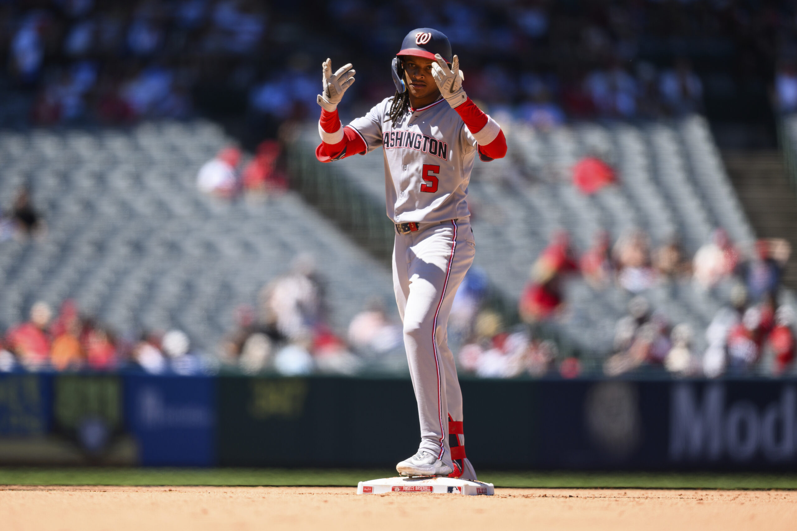 Washington Nationals’ CJ Abrams gestures after hitting an RBI double...