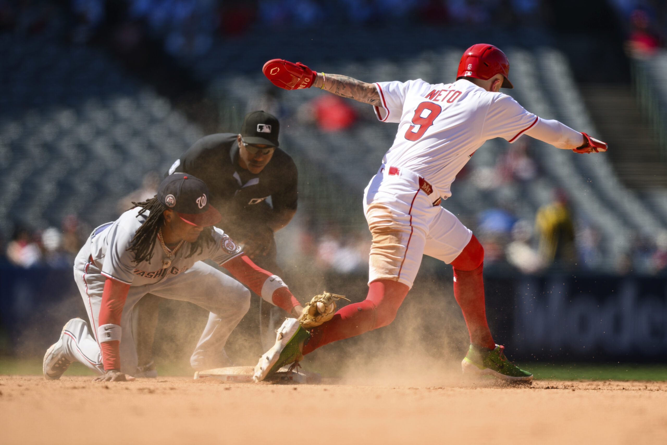 Washington Nationals shortstop CJ Abrams, left, tags out Angels’ Zach...