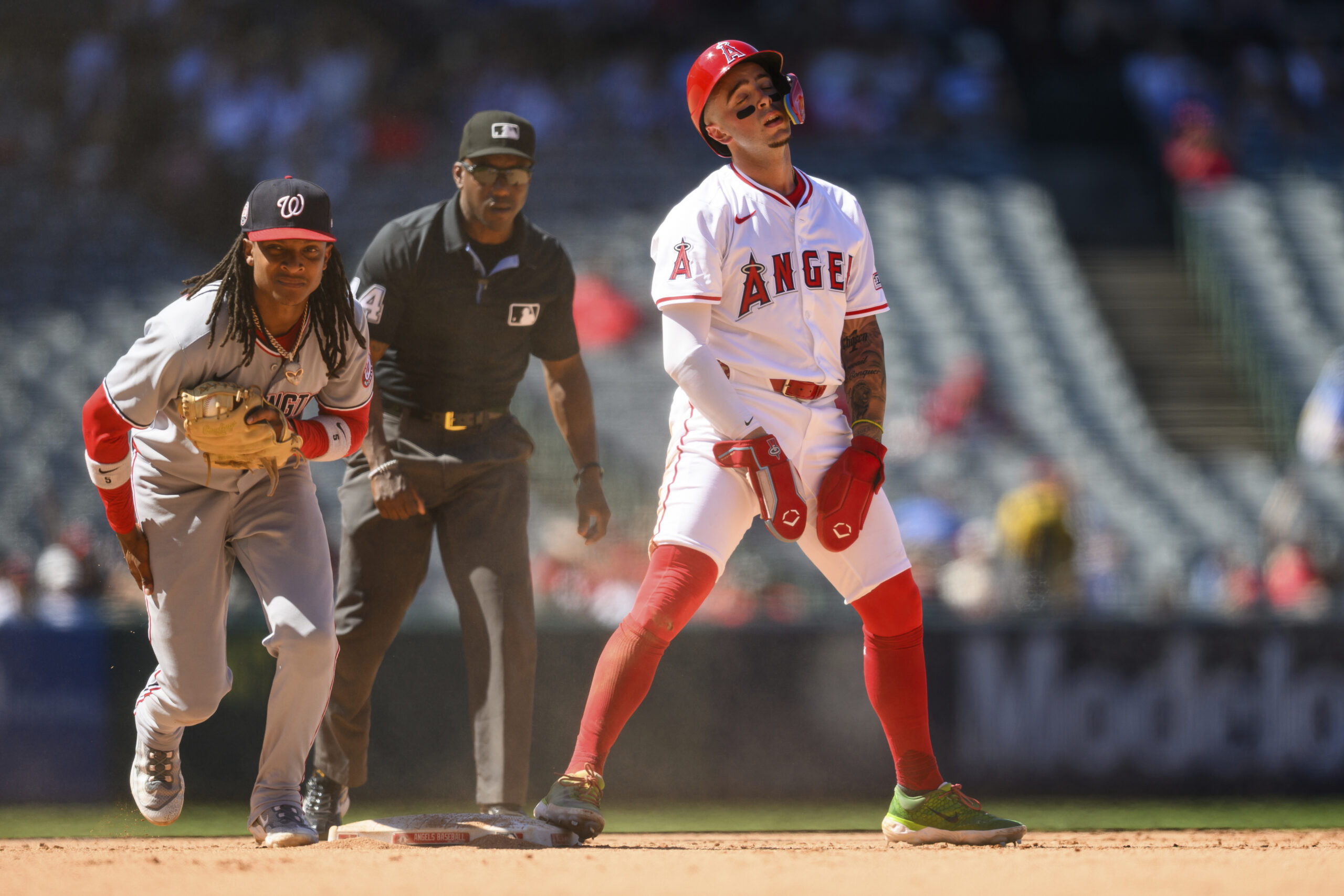 Washington Nationals shortstop CJ Abrams, left, reacts after tagging out...