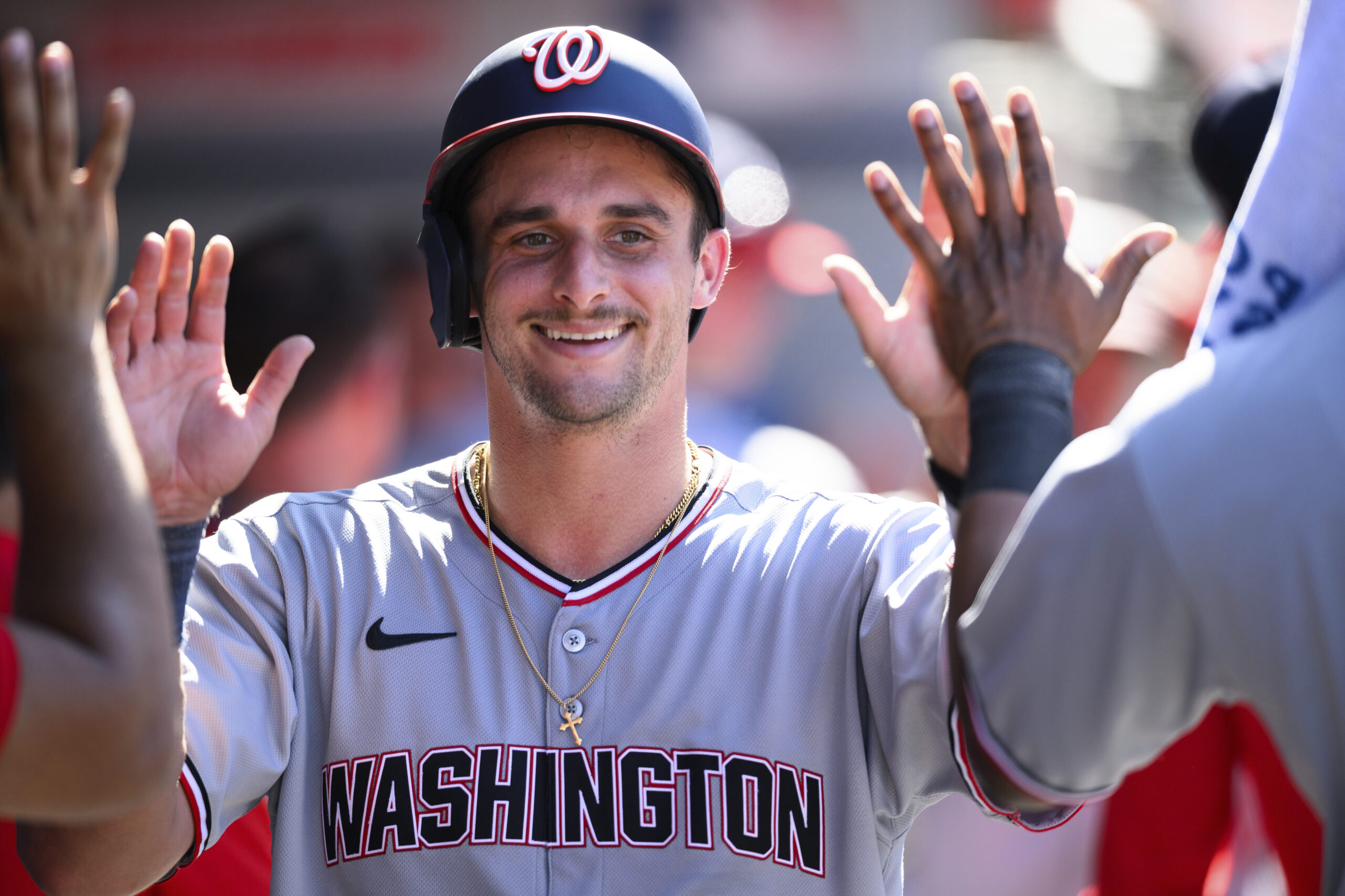 Washington Nationals’ Drew Millas is greeted by teammates after scoring...