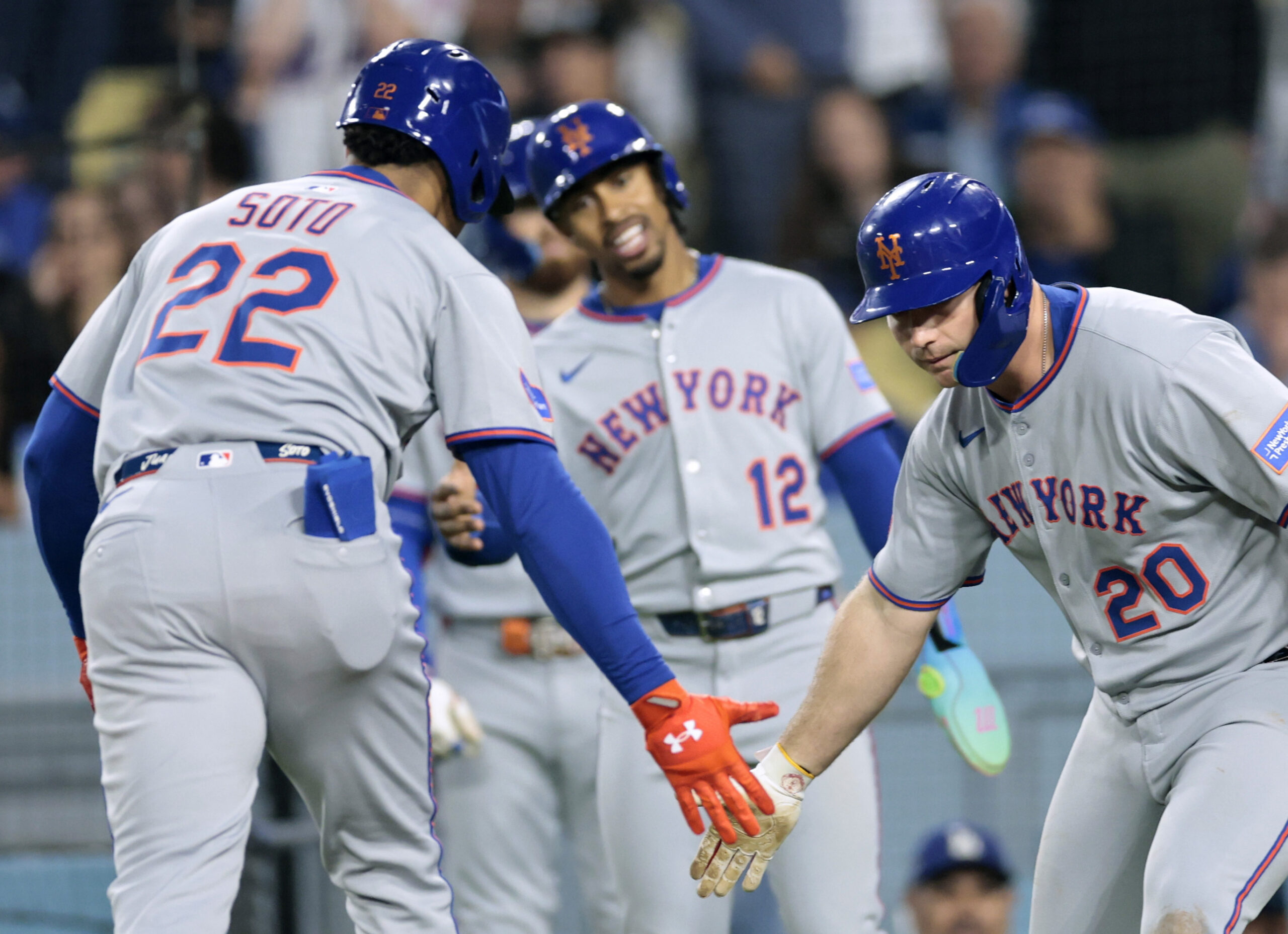 New York Mets star Juan Soto, left, celebrates his two-run...