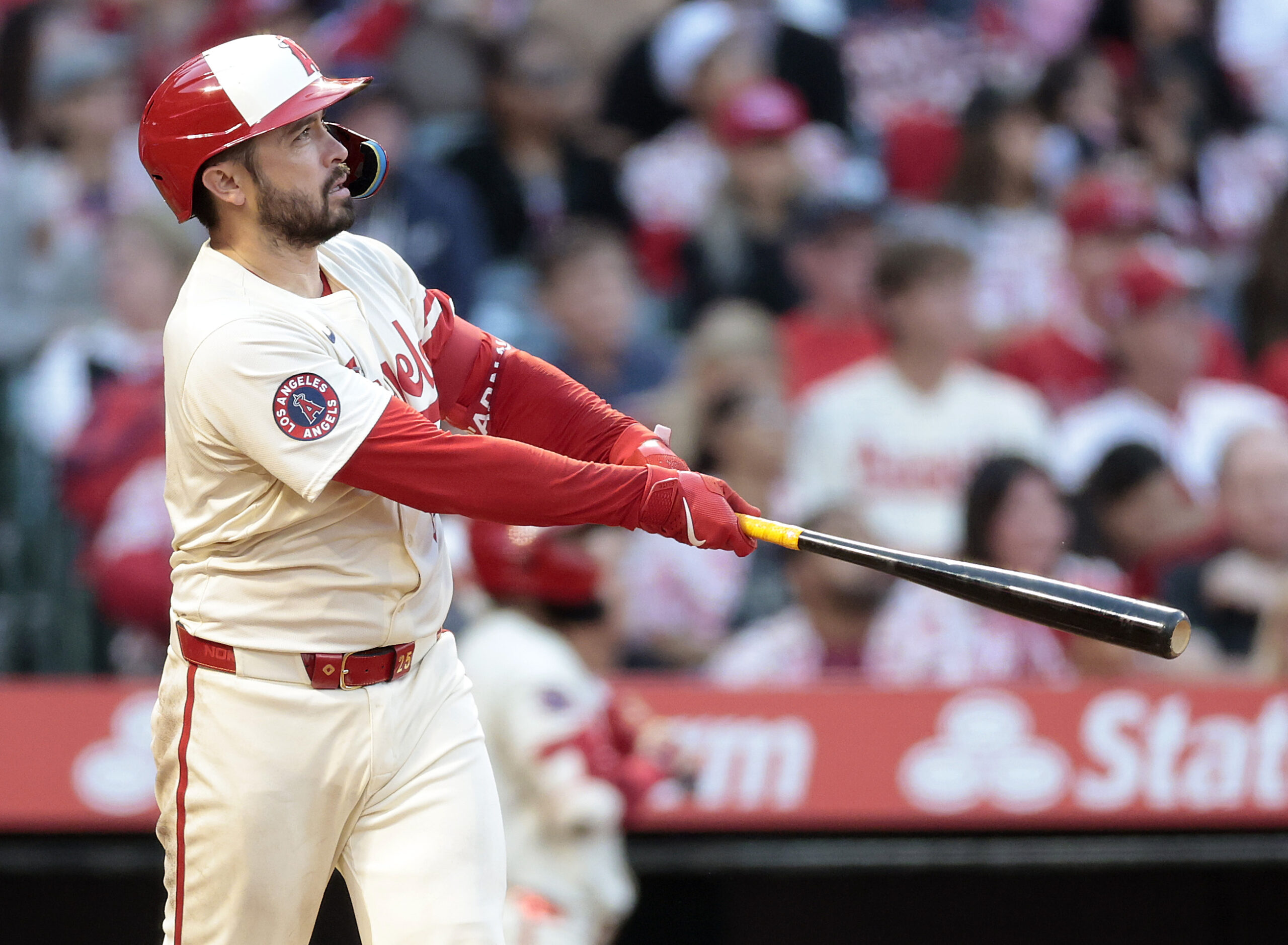 The Angels’ Travis d’Arnaud watches the flight of his two-run...