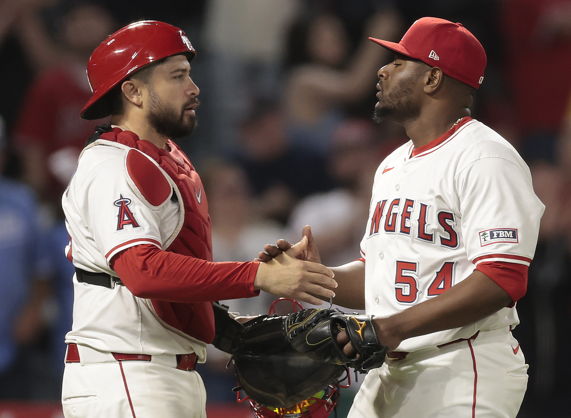 Angels catcher Travis d’Arnaud, left, and relief pitcher Héctor Neris...