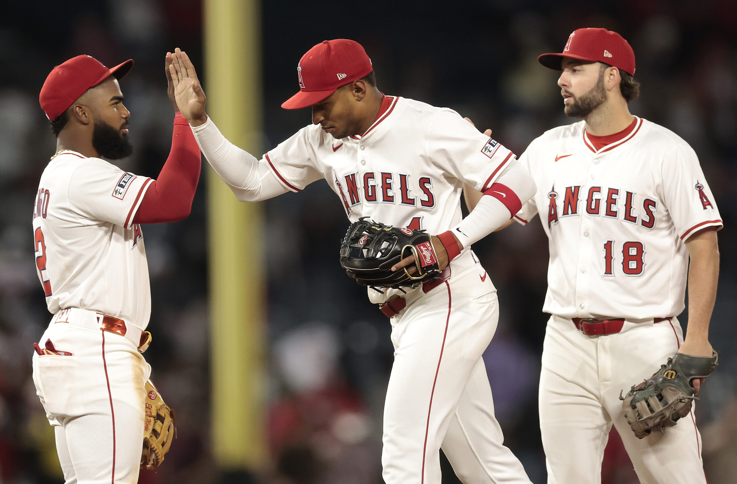 Angels infielders Luis Rengifo, left, Christian Moore, center, and Nolan...