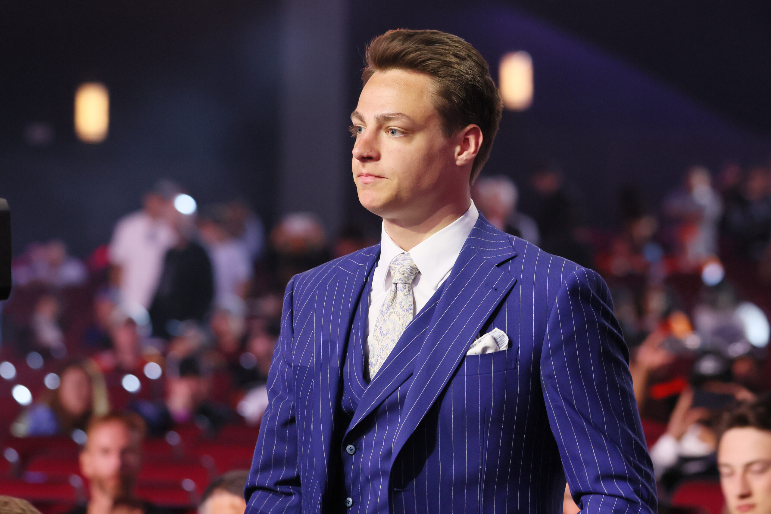 Prospect Henry Brzustewicz walks to the stage after being drafted...