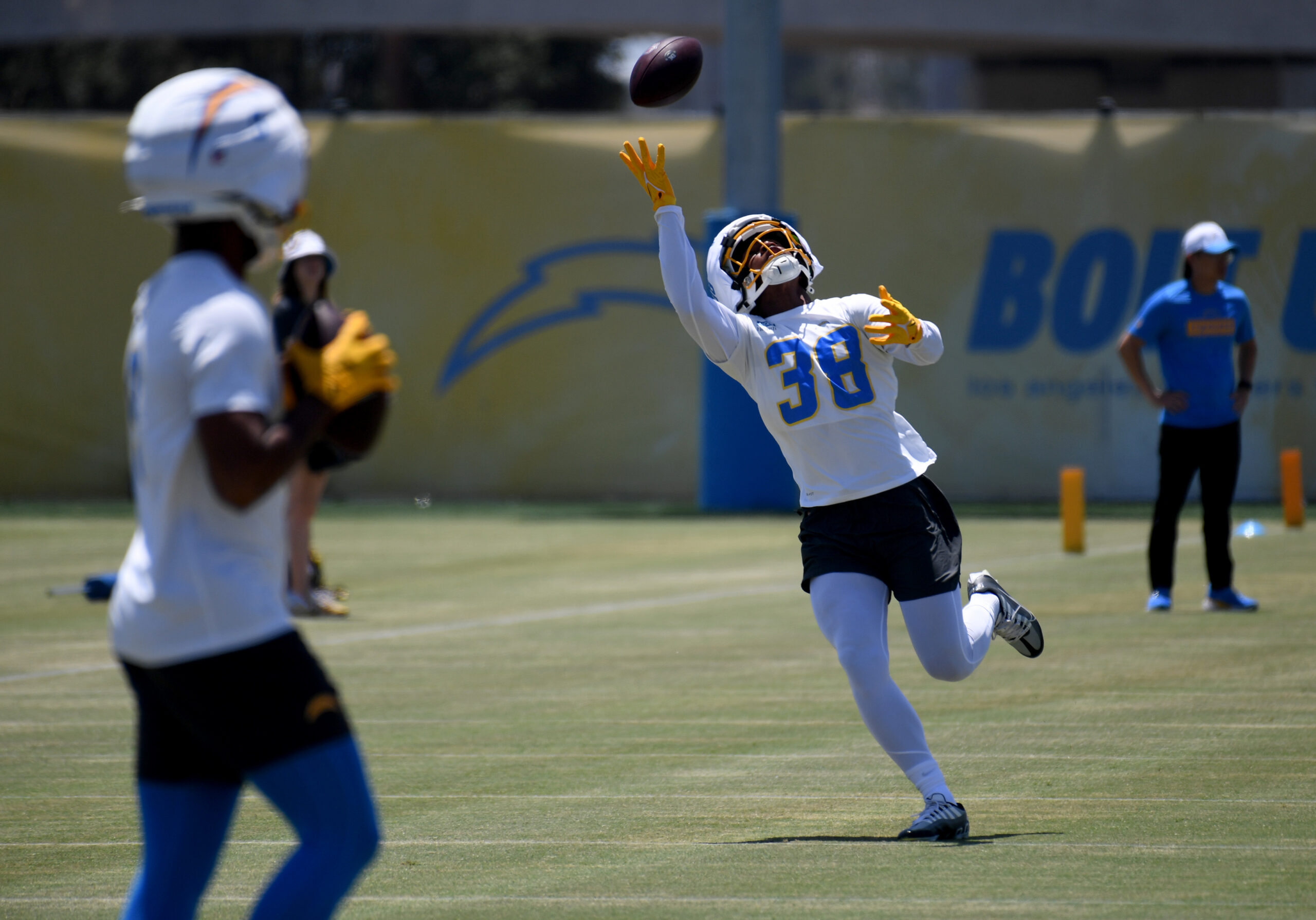 Chargers rookie wide receiver Dalevon Campbell reaches for the ball...
