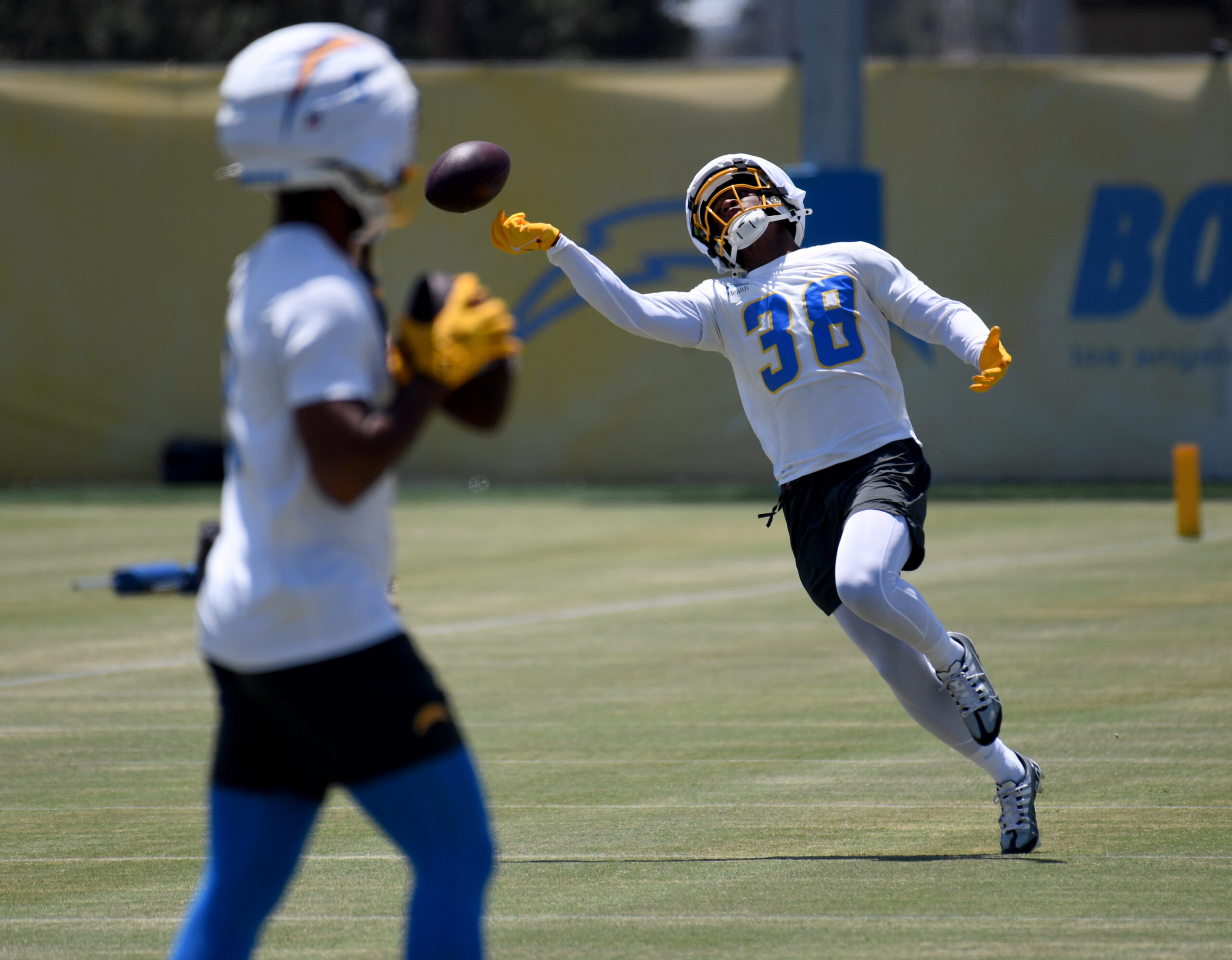 Chargers rookie wide receiver Dalevon Campbell reaches for the ball...