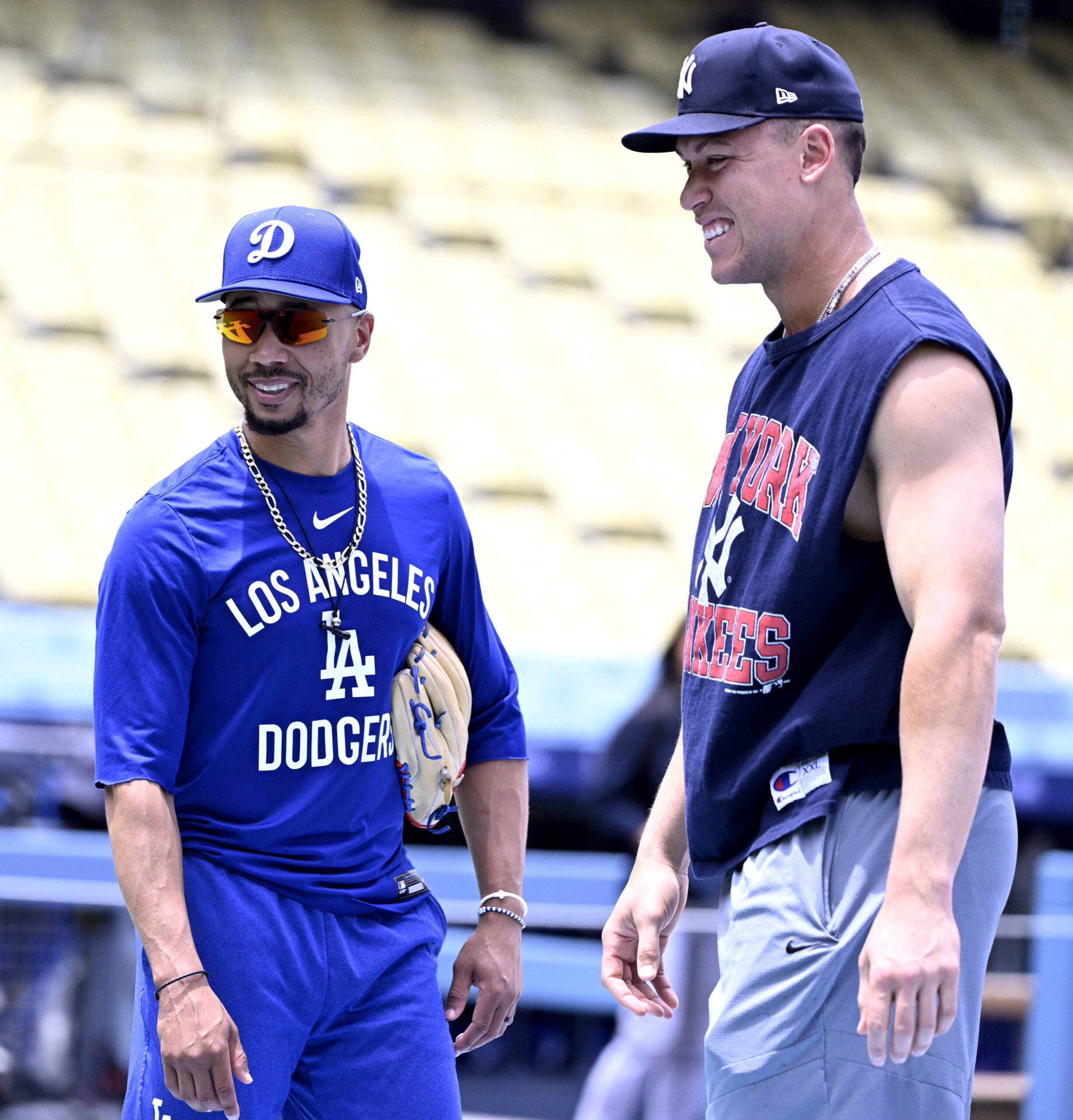 Mookie Betts, left, of the Dodgers talks with Aaron Judge...