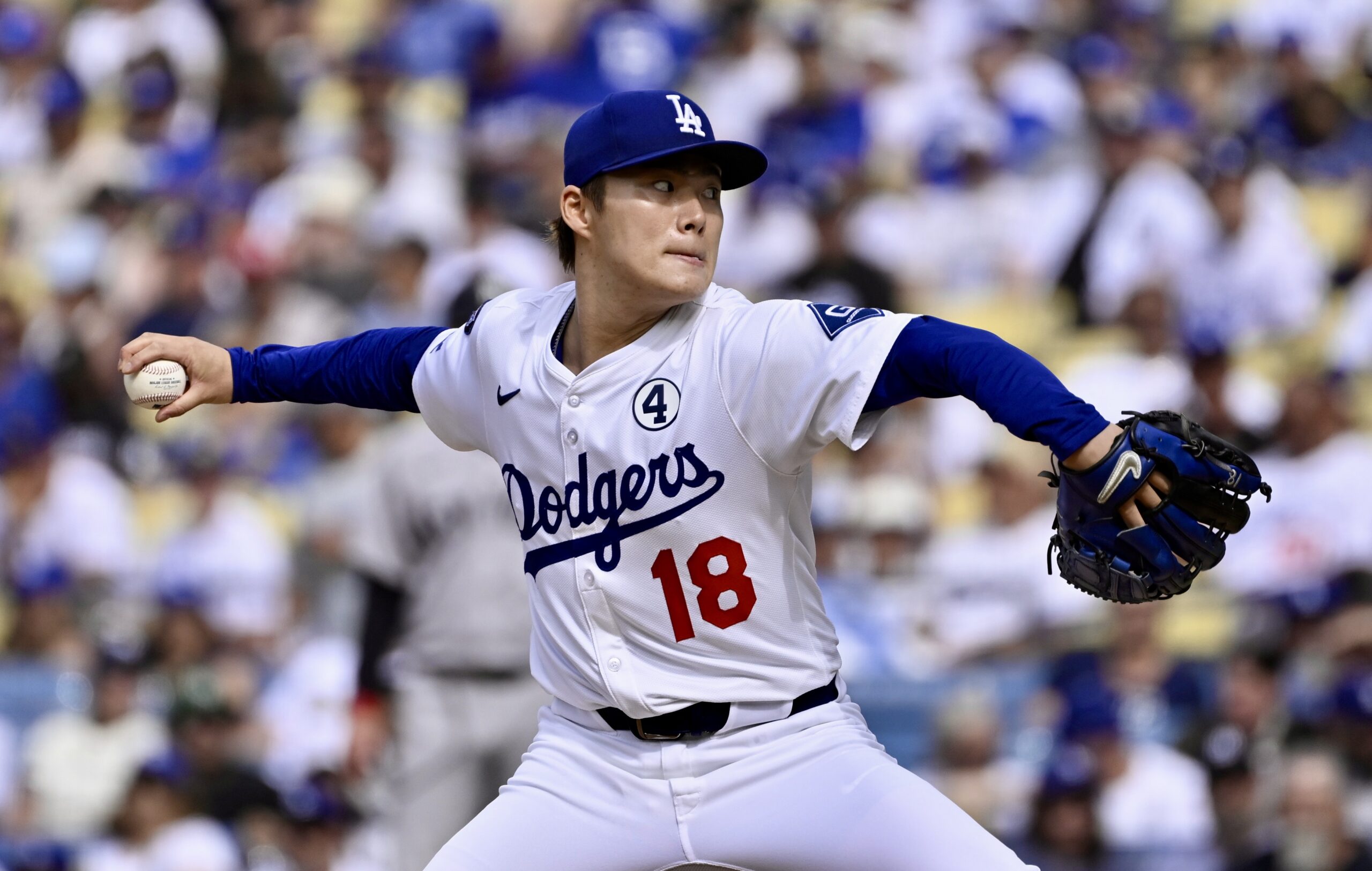 Starting pitcher Yoshinobu Yamamoto #18 of the Dodgers throws to...