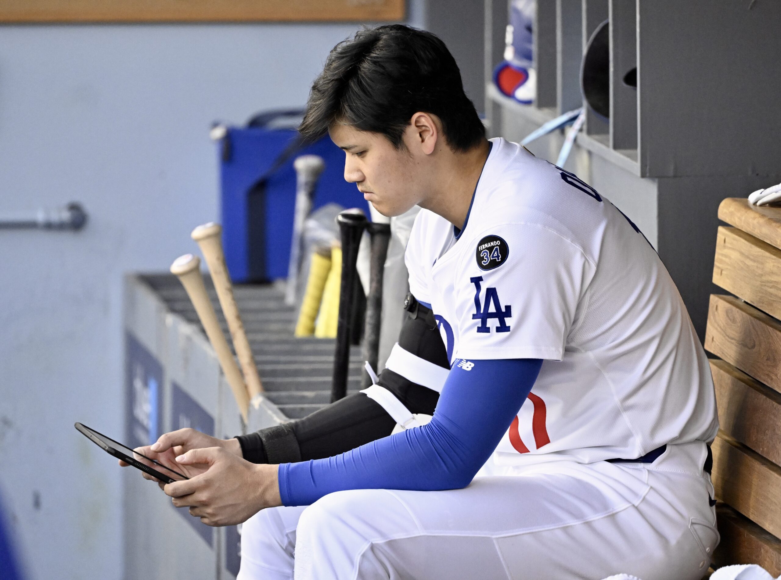 Shohei Ohtani #17 of the Dodgers looks at his tablet...