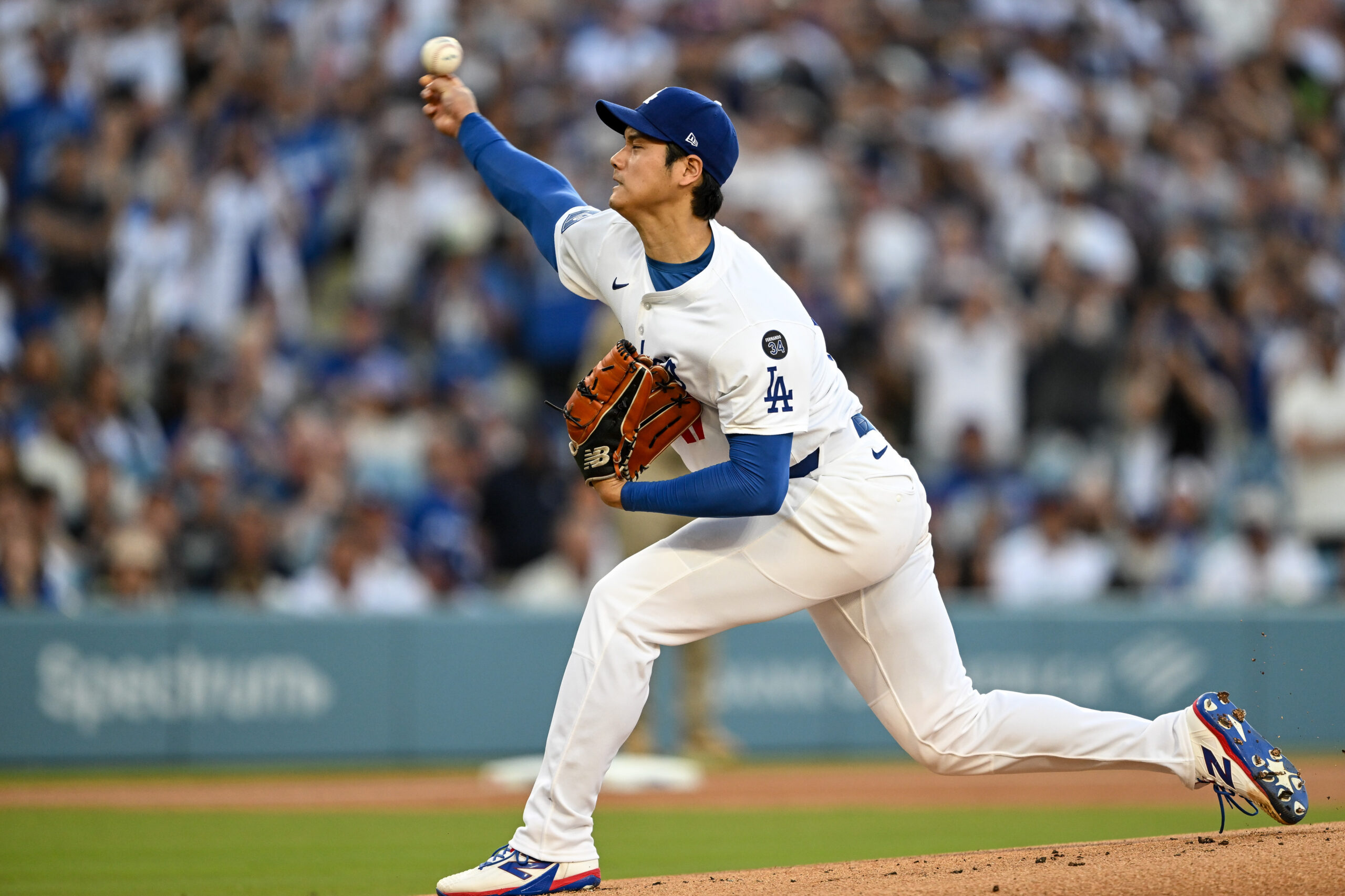 Dodgers starting pitcher Shohei Ohtani throws to the plate during...