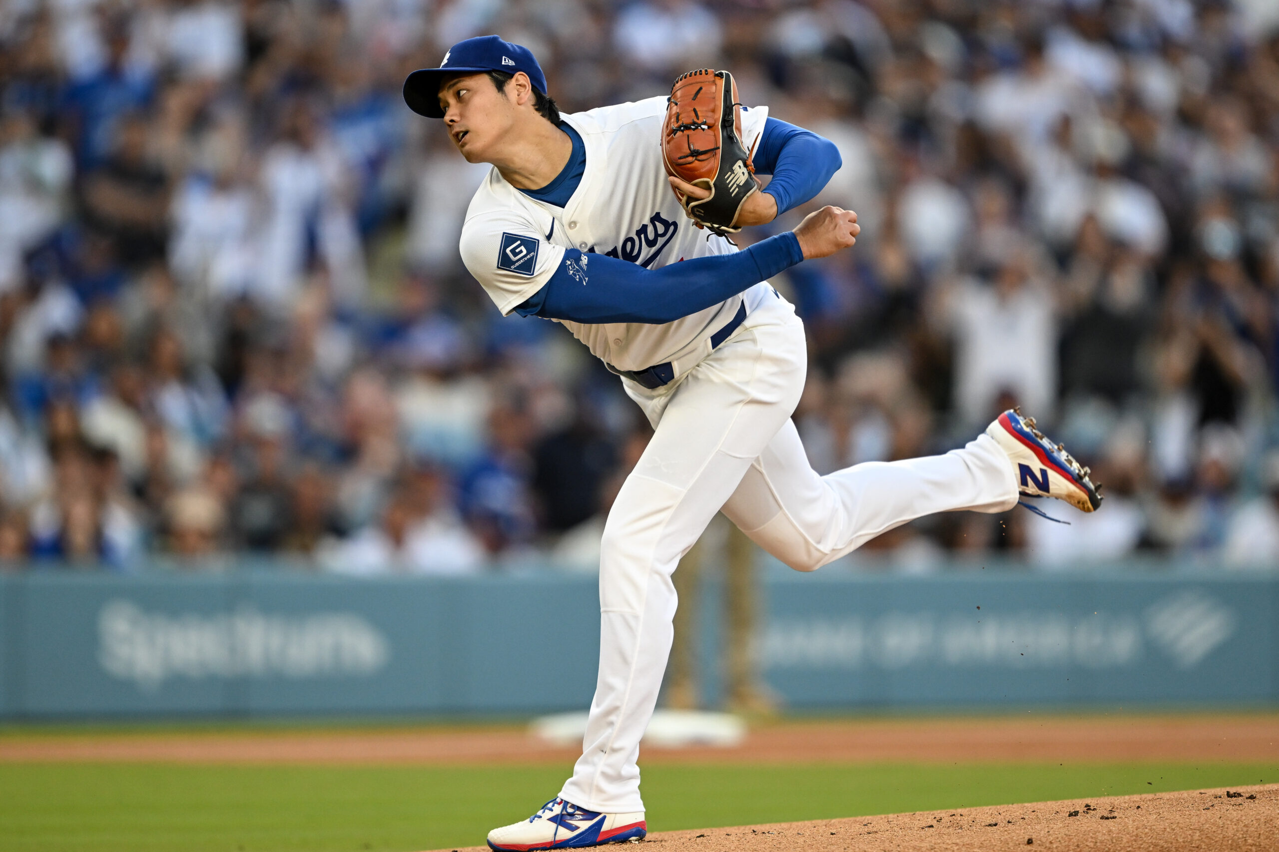 Dodgers starting pitcher Shohei Ohtani throws to the plate during...
