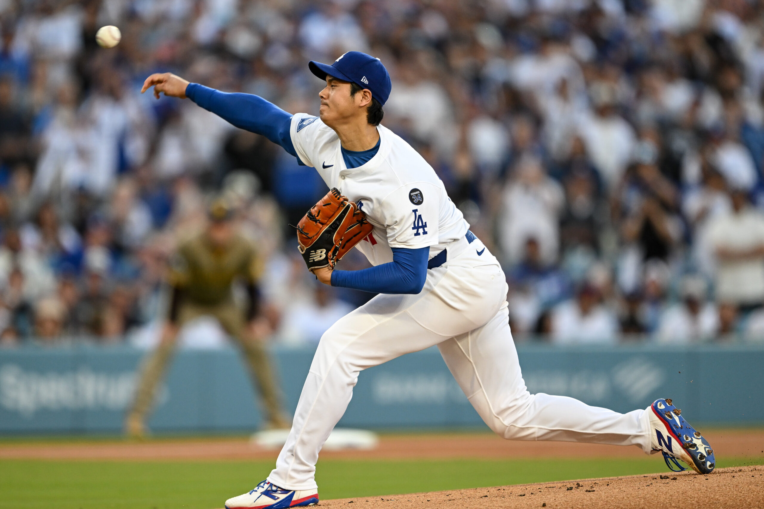 Dodgers starting pitcher Shohei Ohtani throws to the plate during...