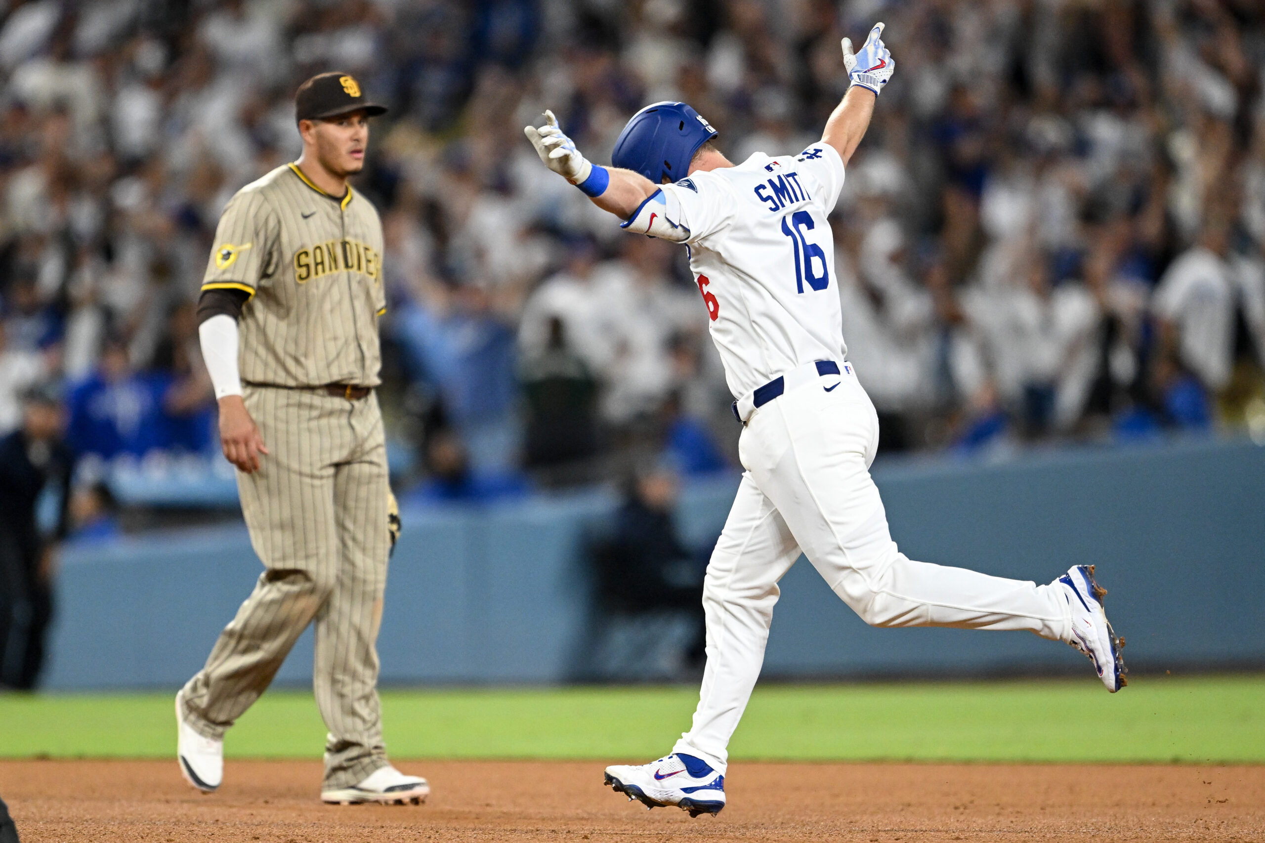 The Dodgers’ Will Smith gestures as he runs the bases...