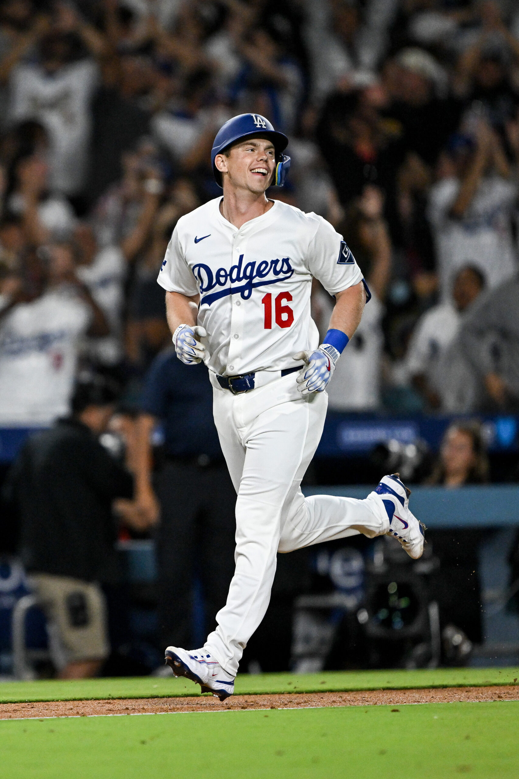 The Dodgers’ Will Smith smiles as he runs the bases...