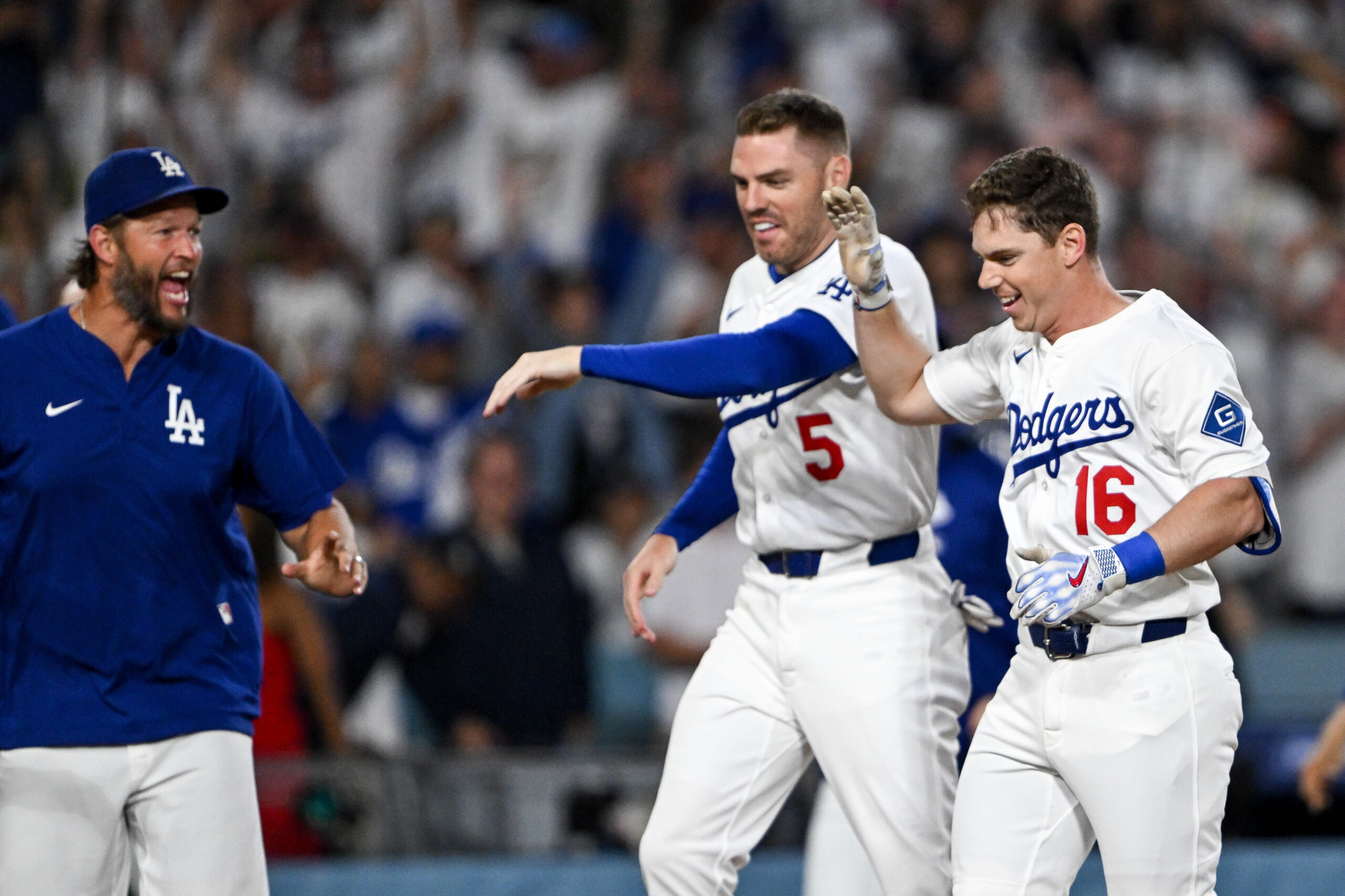 The Dodgers’ Will Smith, right, is greeted by teammates, including...