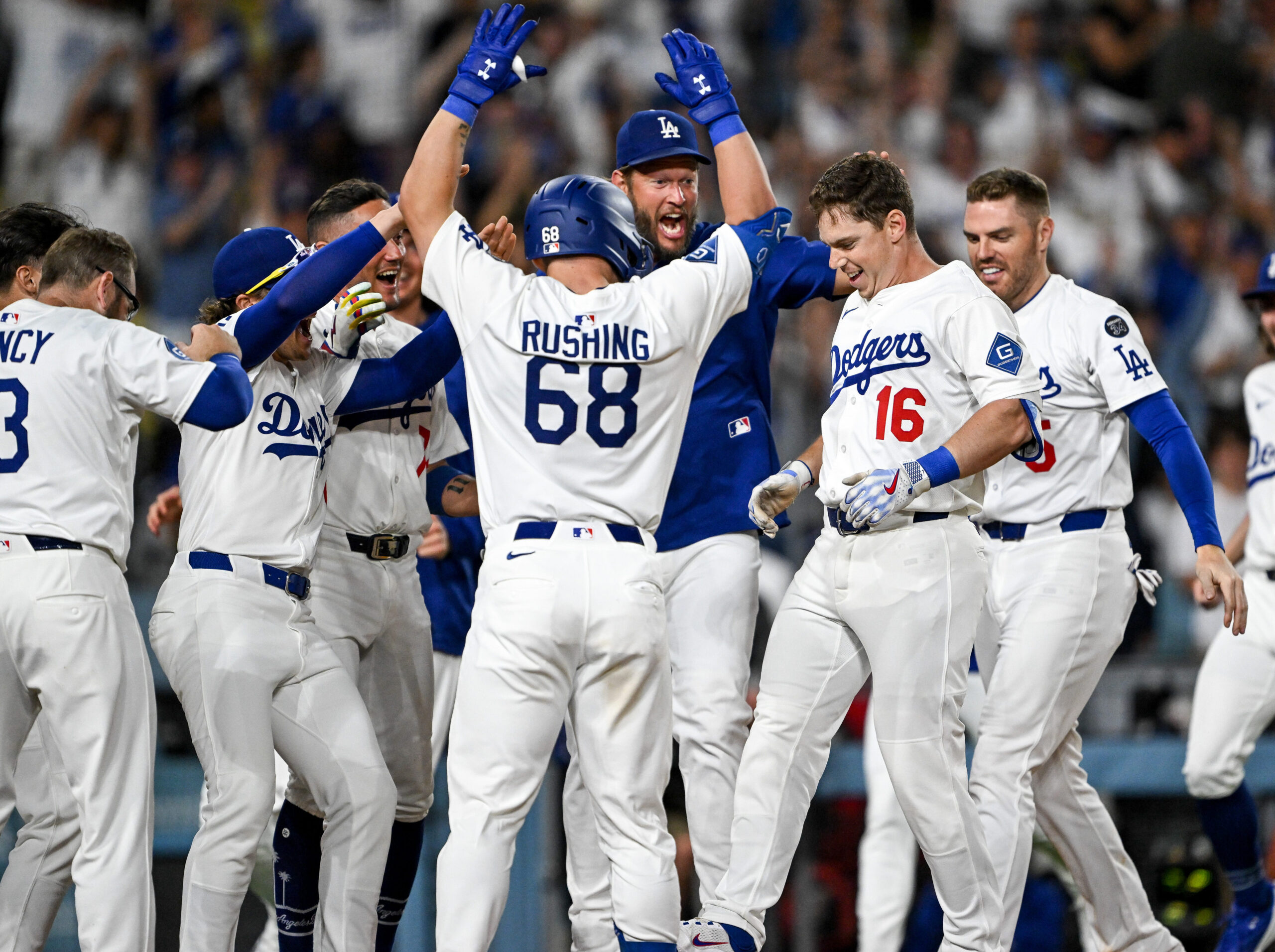 The Dodgers’ Will Smith (16) is mobbed by teammates at...