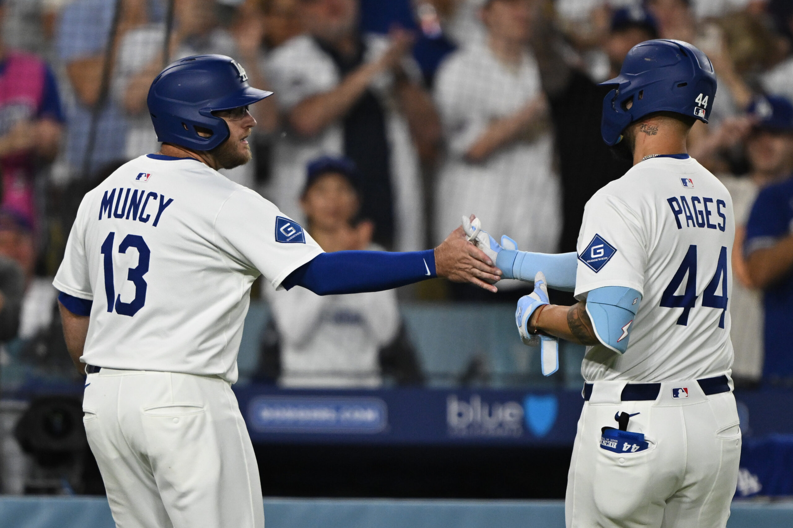 The Dodgers’ Max Muncy, left, greets Andy Pages after Pages...