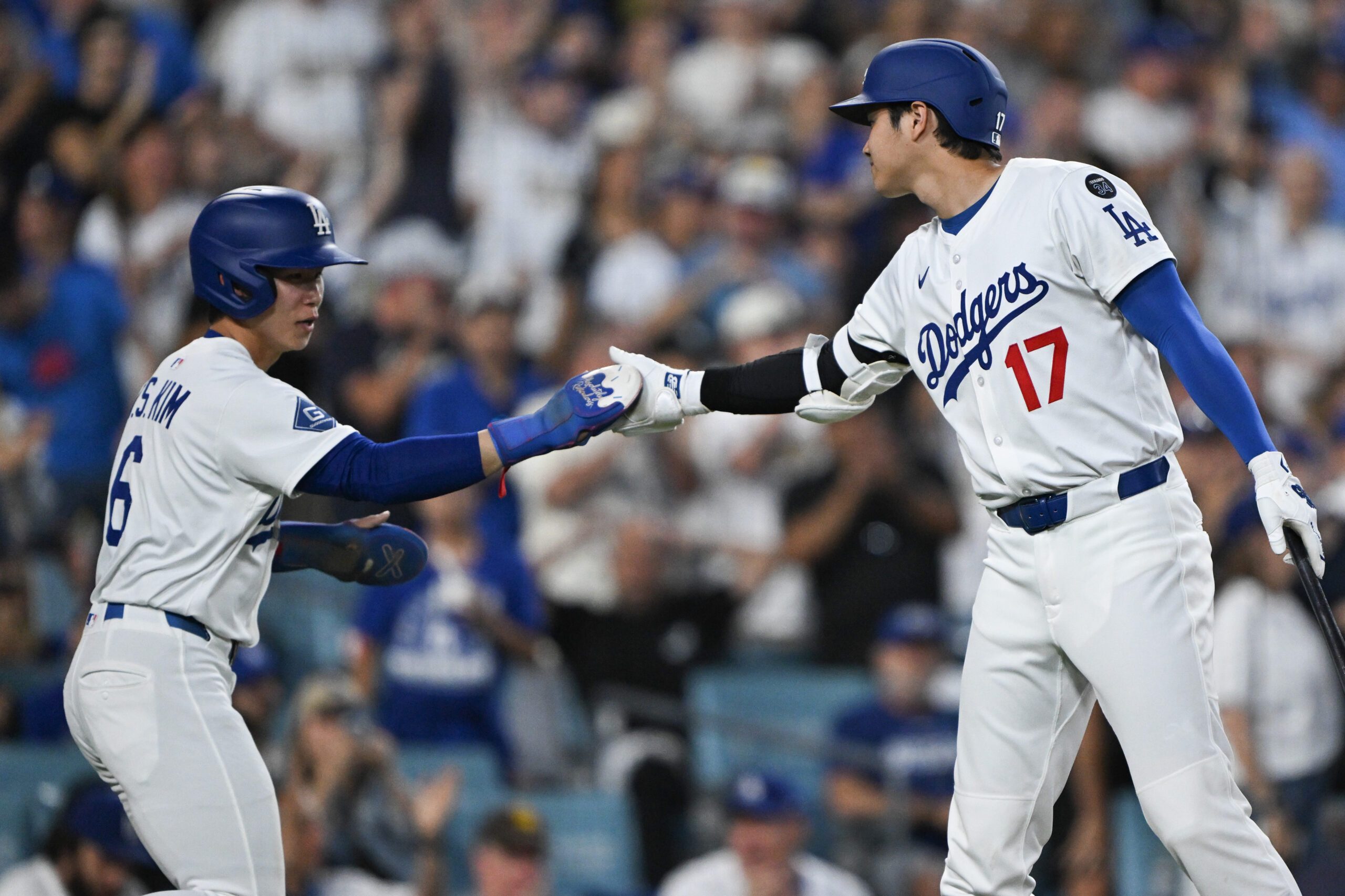 Dodgers star Shohei Ohtani, right, greets teammate Hyeseong Kim after...