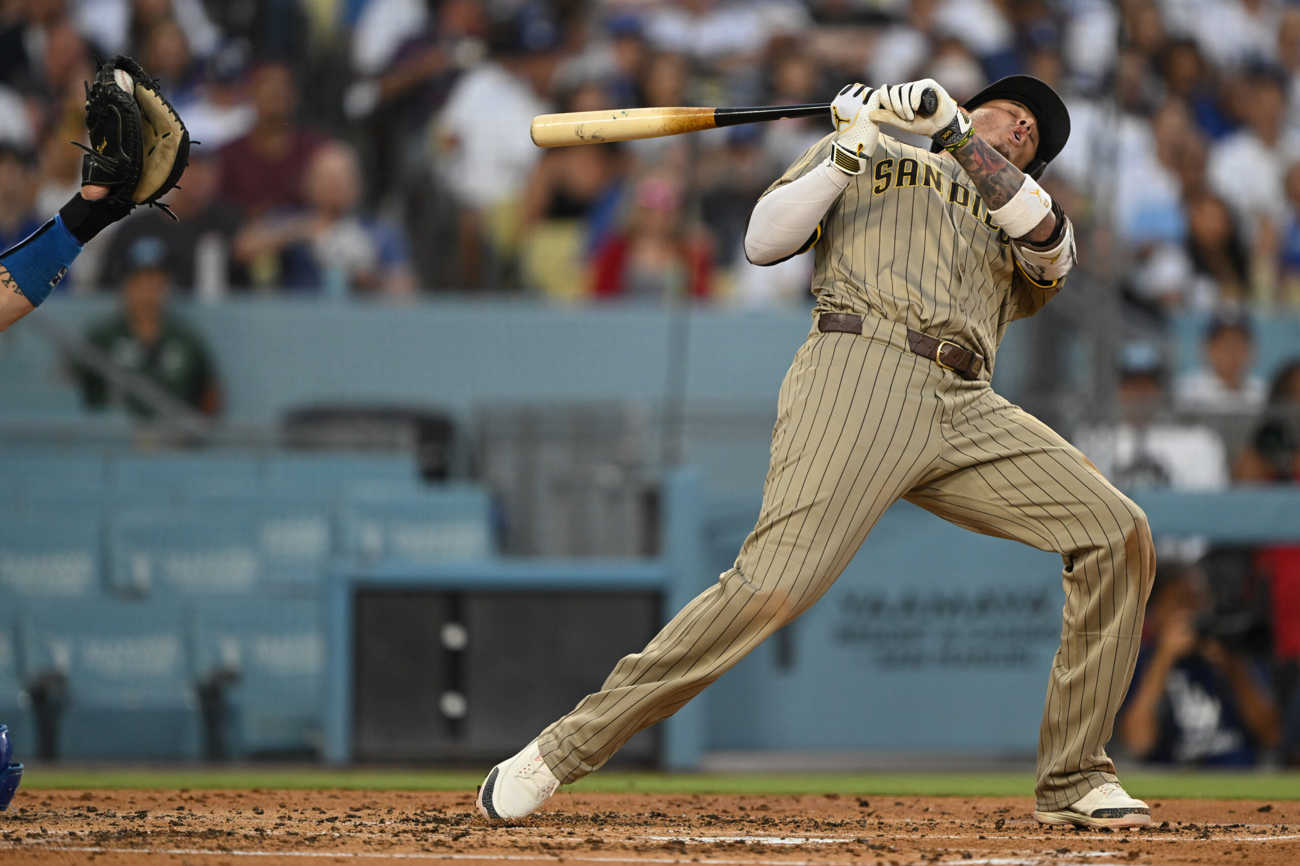 San Diego Padres star Manny Machado dodges a close pitch...