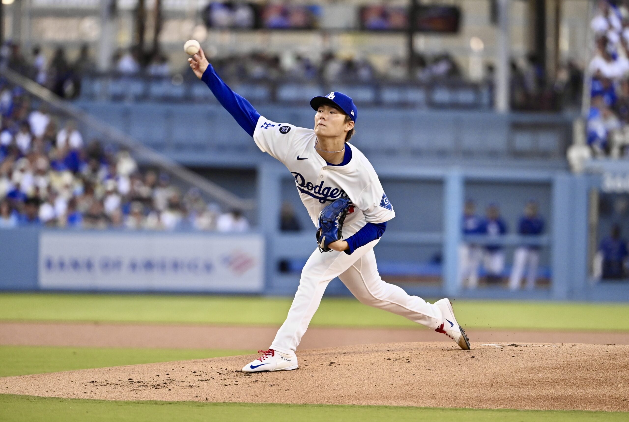 Dodgers starting pitcher Yoshinobu Yamamoto throws to the plate against...