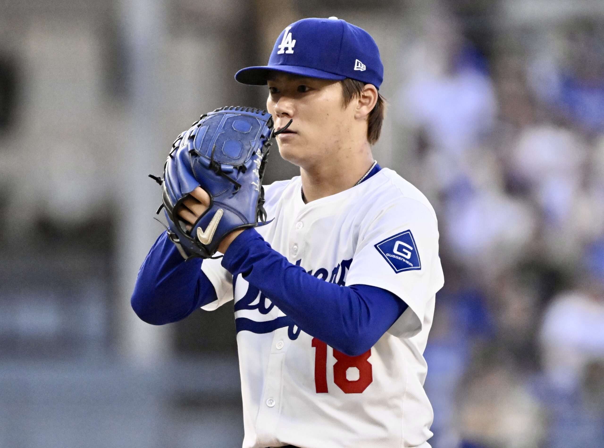 Dodgers starting pitcher Yoshinobu Yamamoto throws to the plate against...