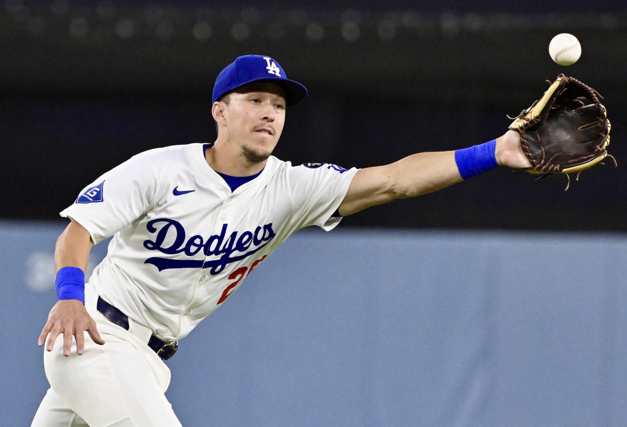 Dodgers second baseman Tommy Edman can’t reach a ball hit...