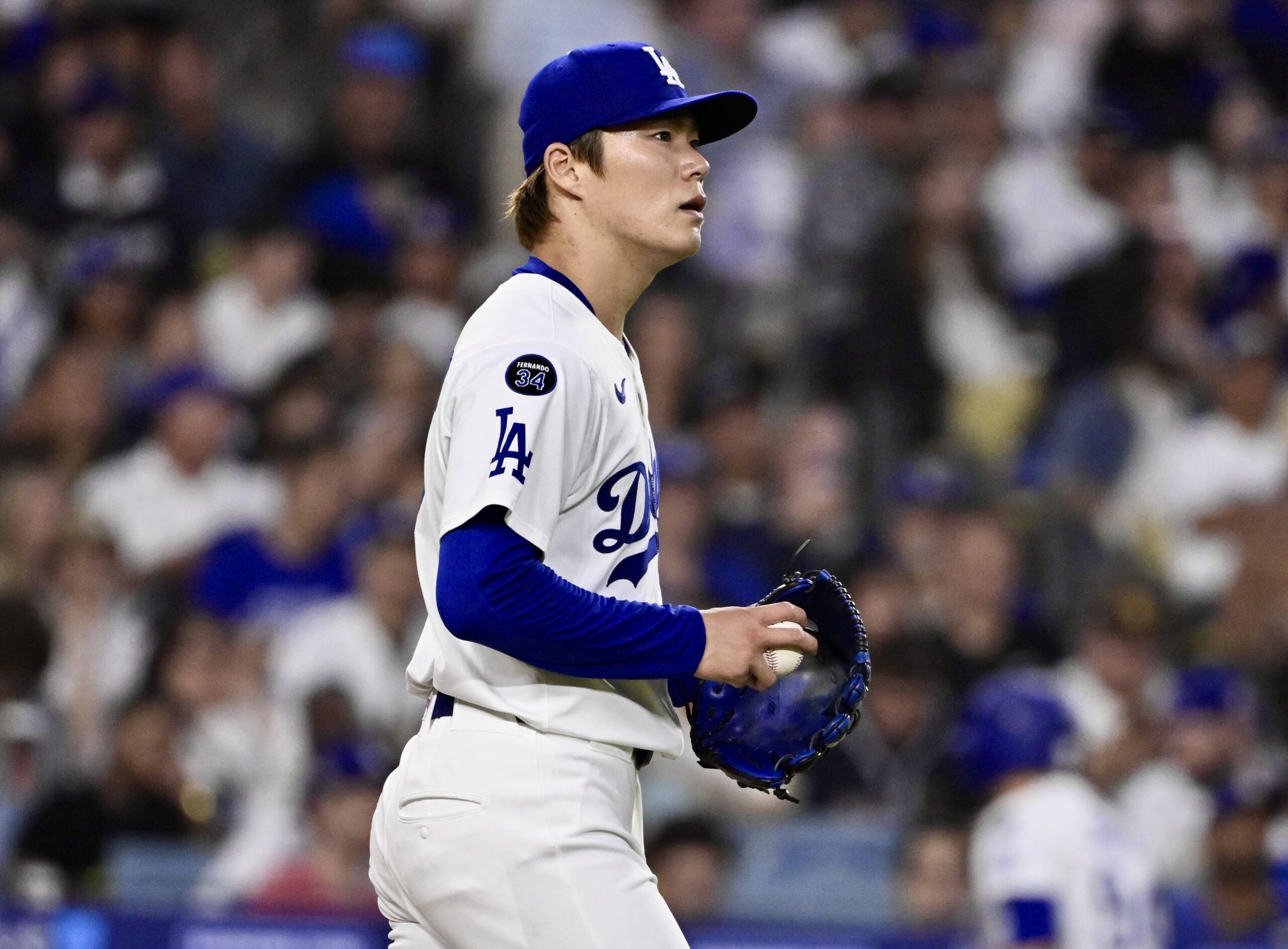 Dodgers starting pitcher Yoshinobu Yamamoto looks on after Xander Bogaerts...