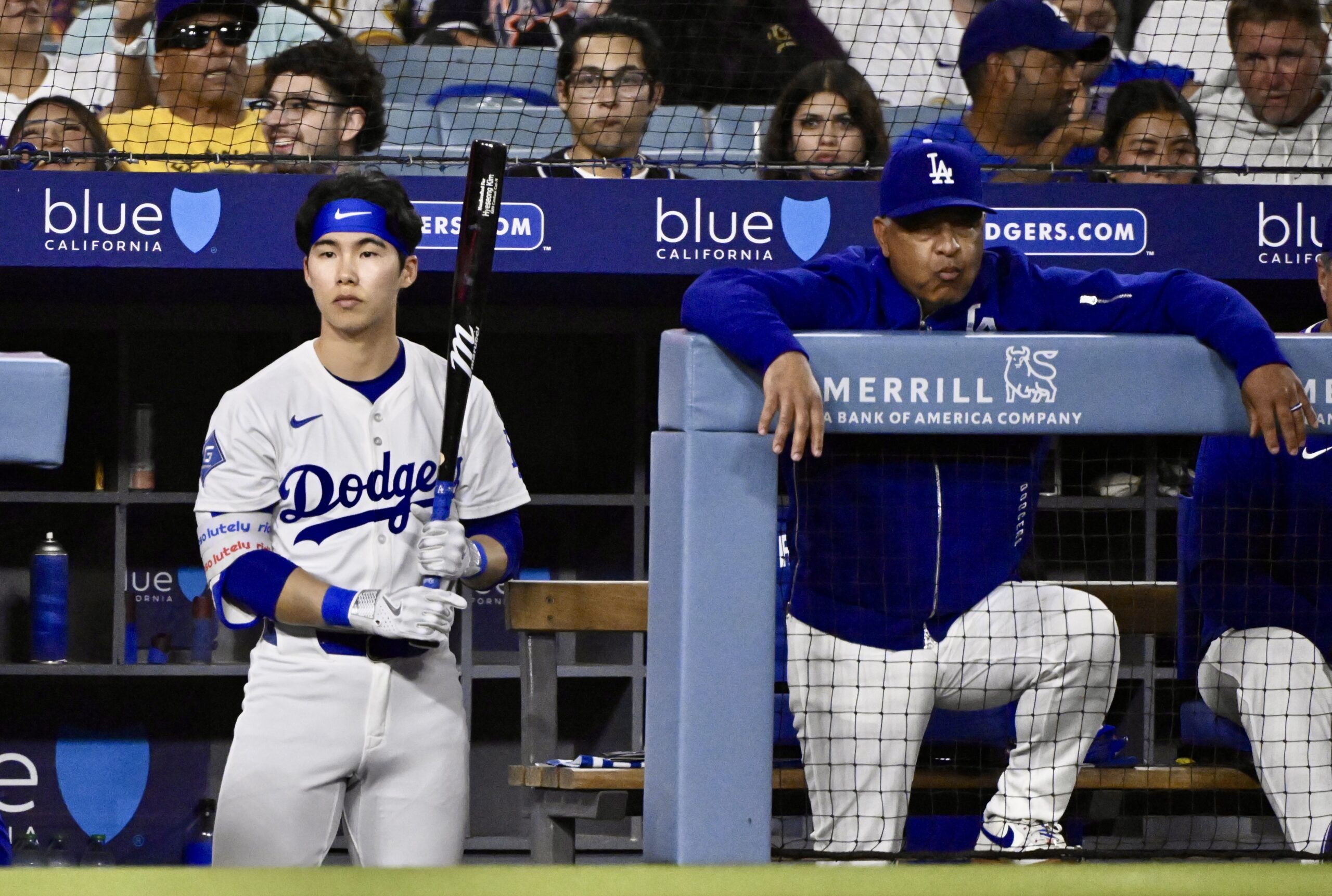 Dodgers utility man Hyeseong Kim, left, waits his turn to...