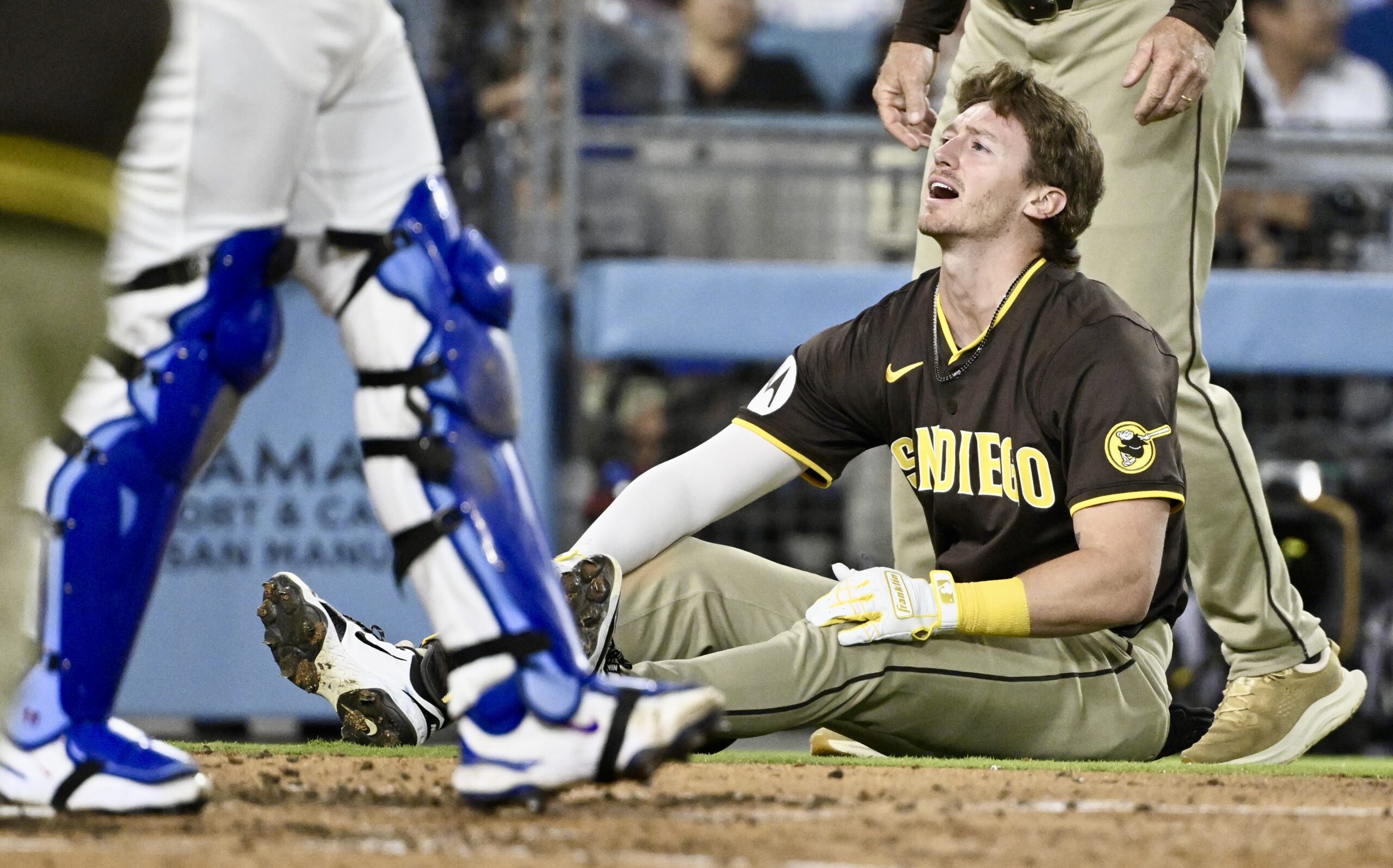 The San Diego Padres’ Bryce Johnson reacts after being hit...