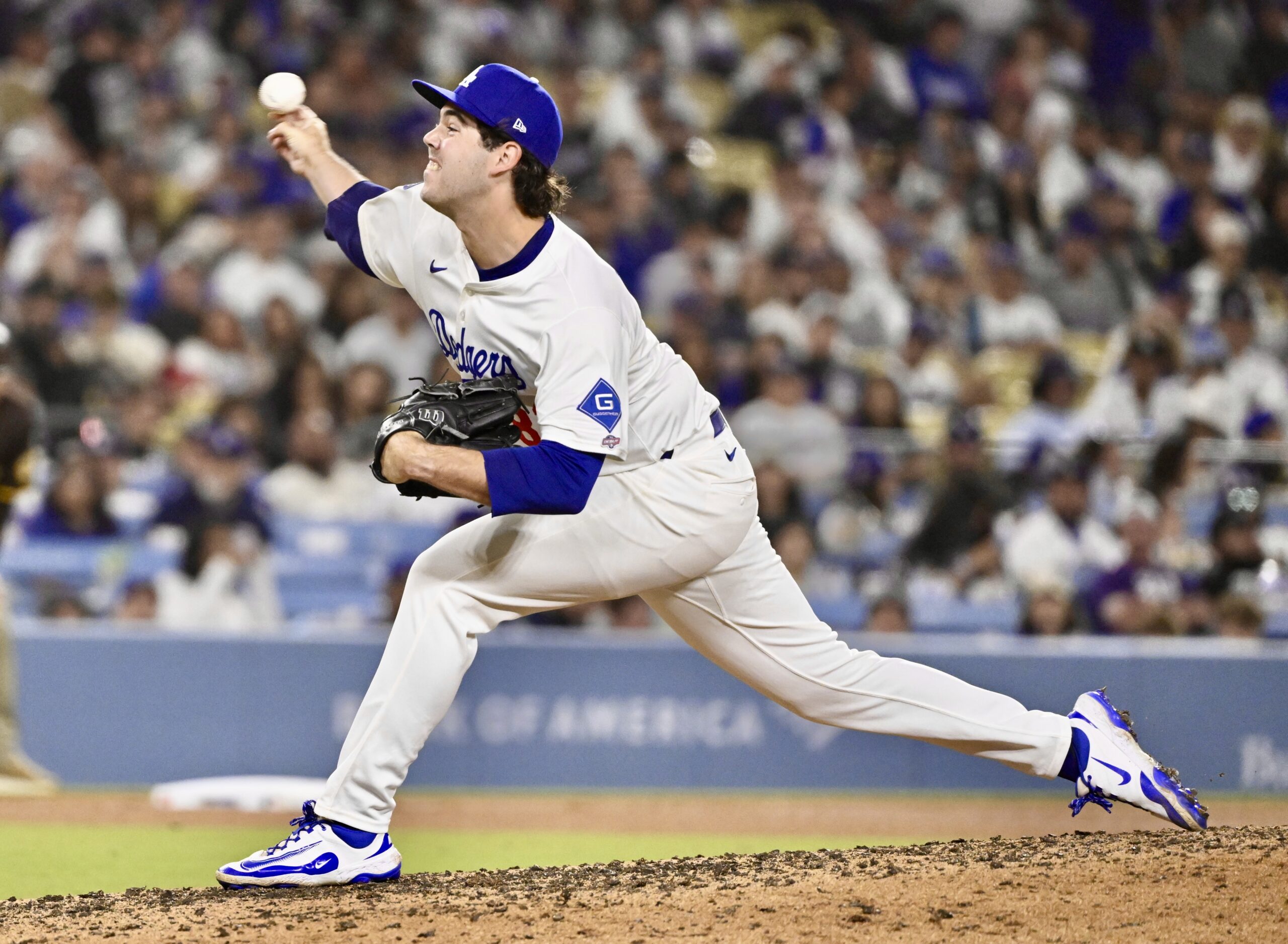 Dodgers relief pitcher Jack Little throws to the plate against...