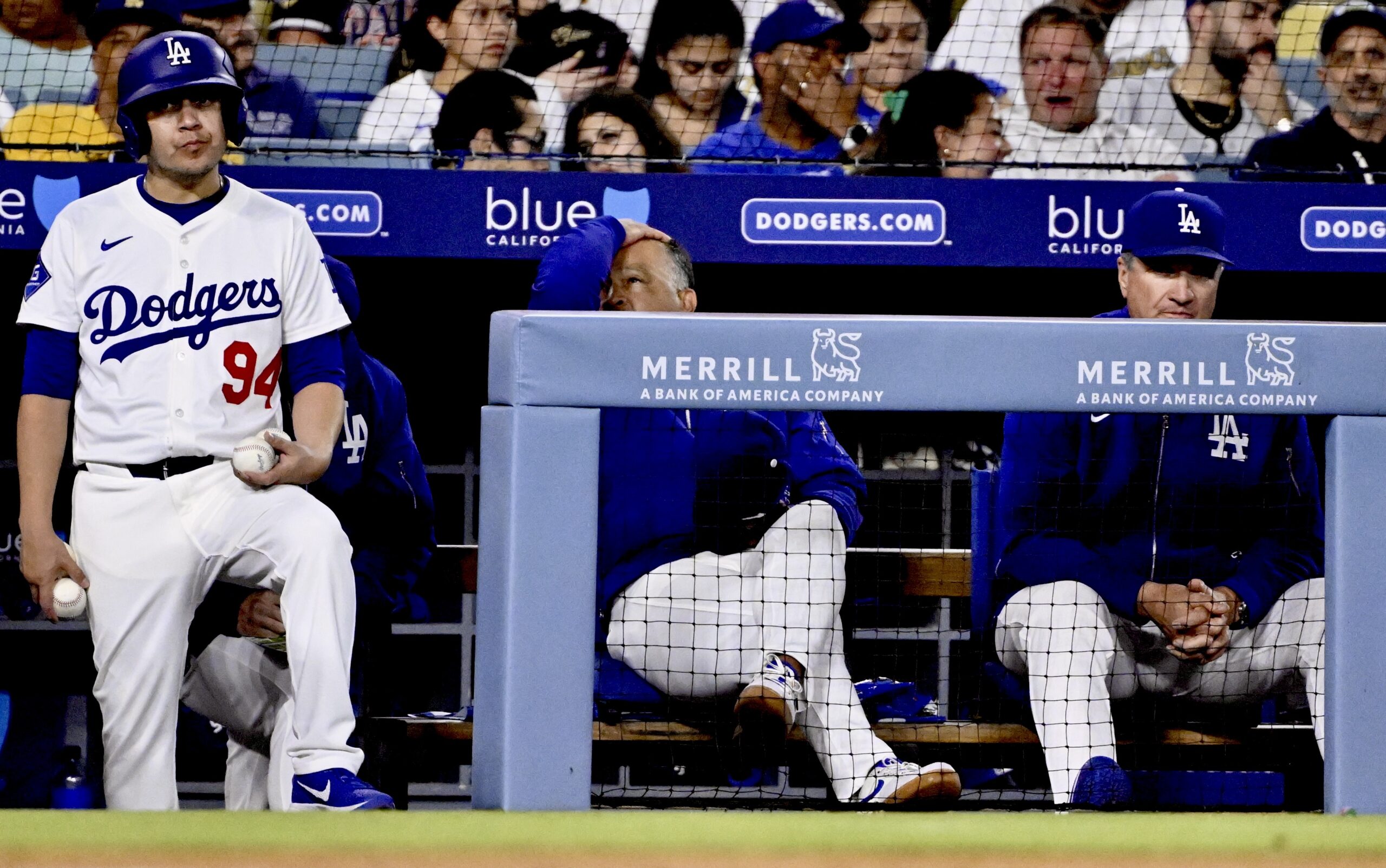 Dodgers manager Dave Roberts, center, reacts after the San Diego...