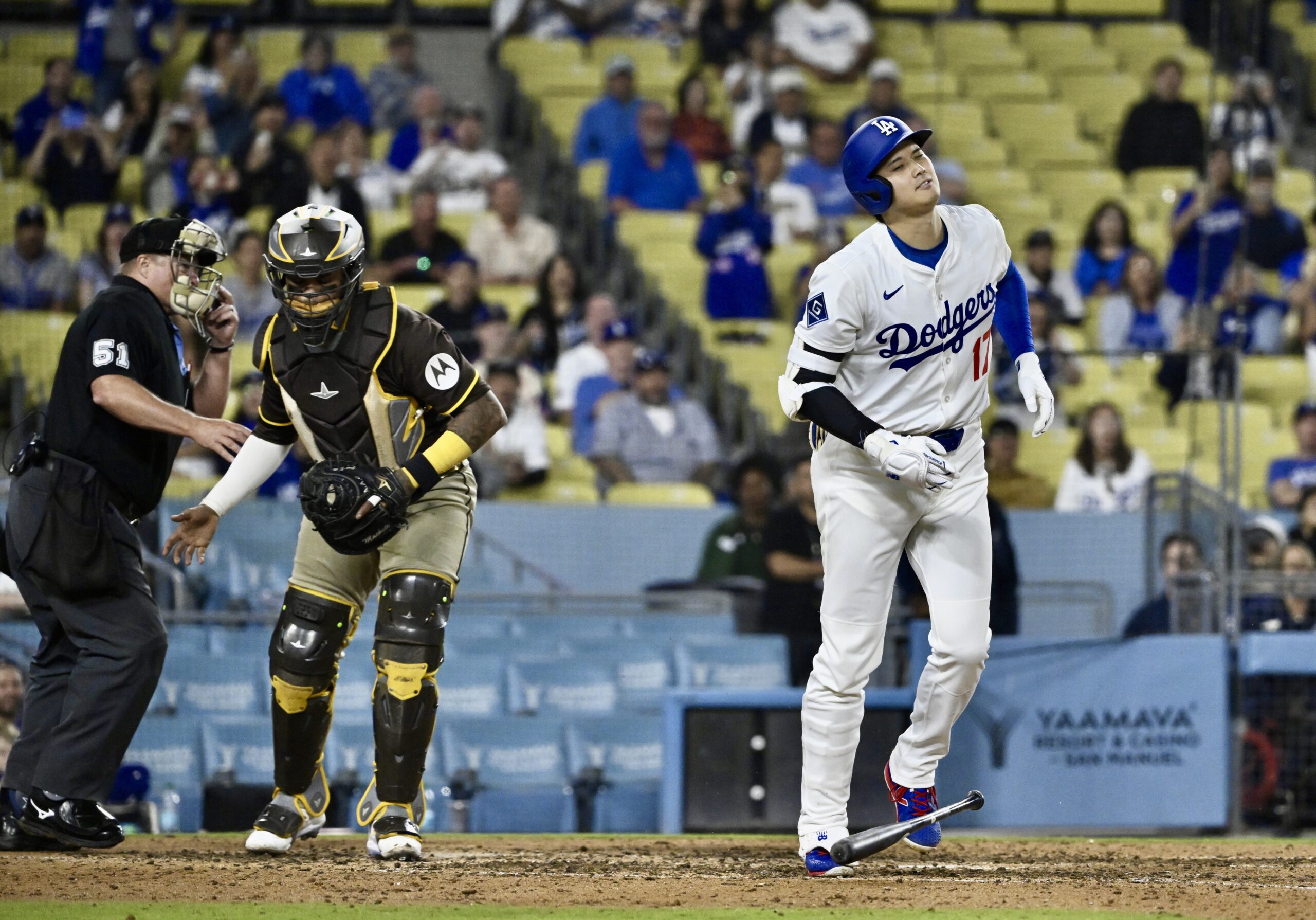 Dodgers star Shohei Ohtani begins to walk to first base...