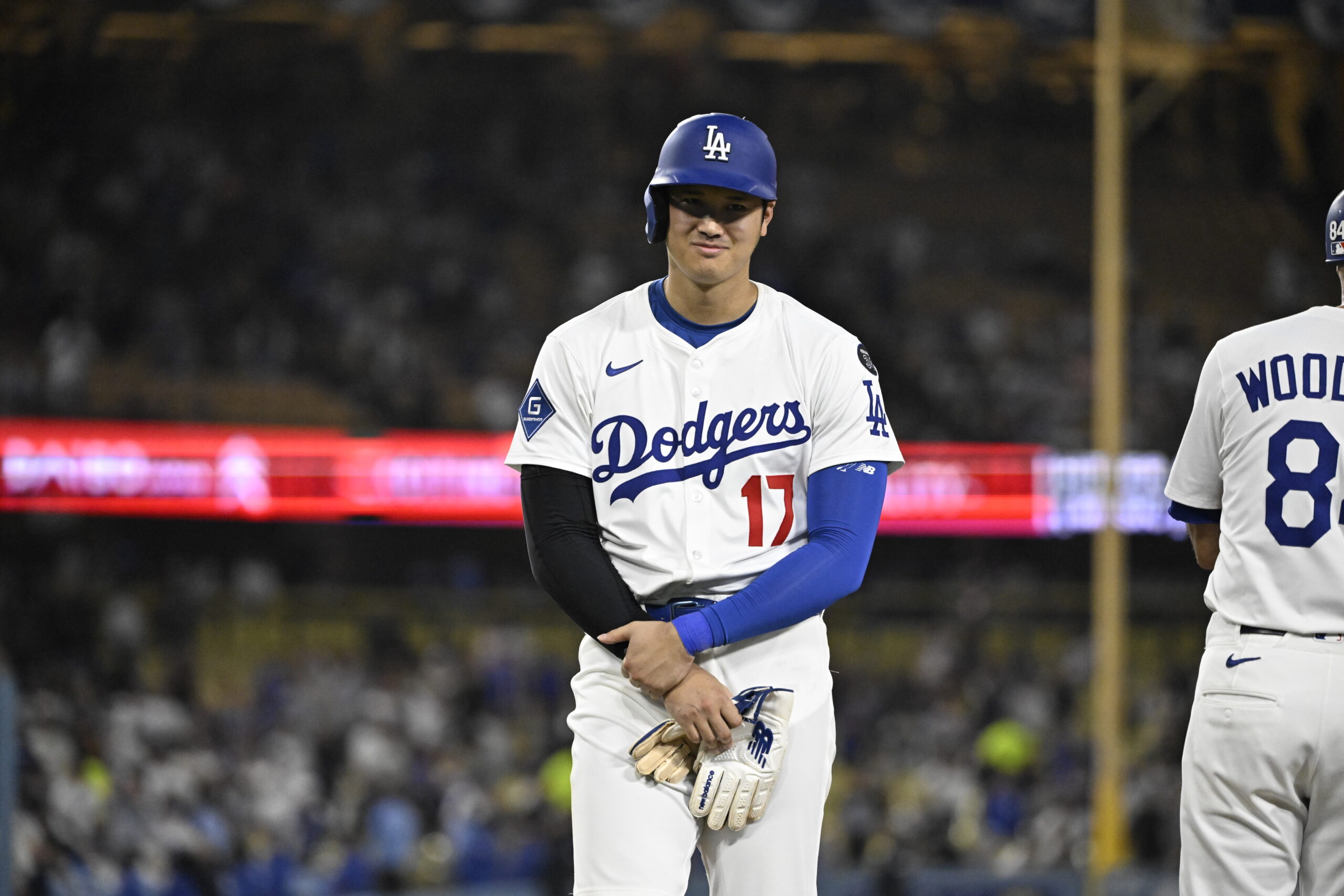 Dodgers star Shohei Ohtani stands at first base after being...