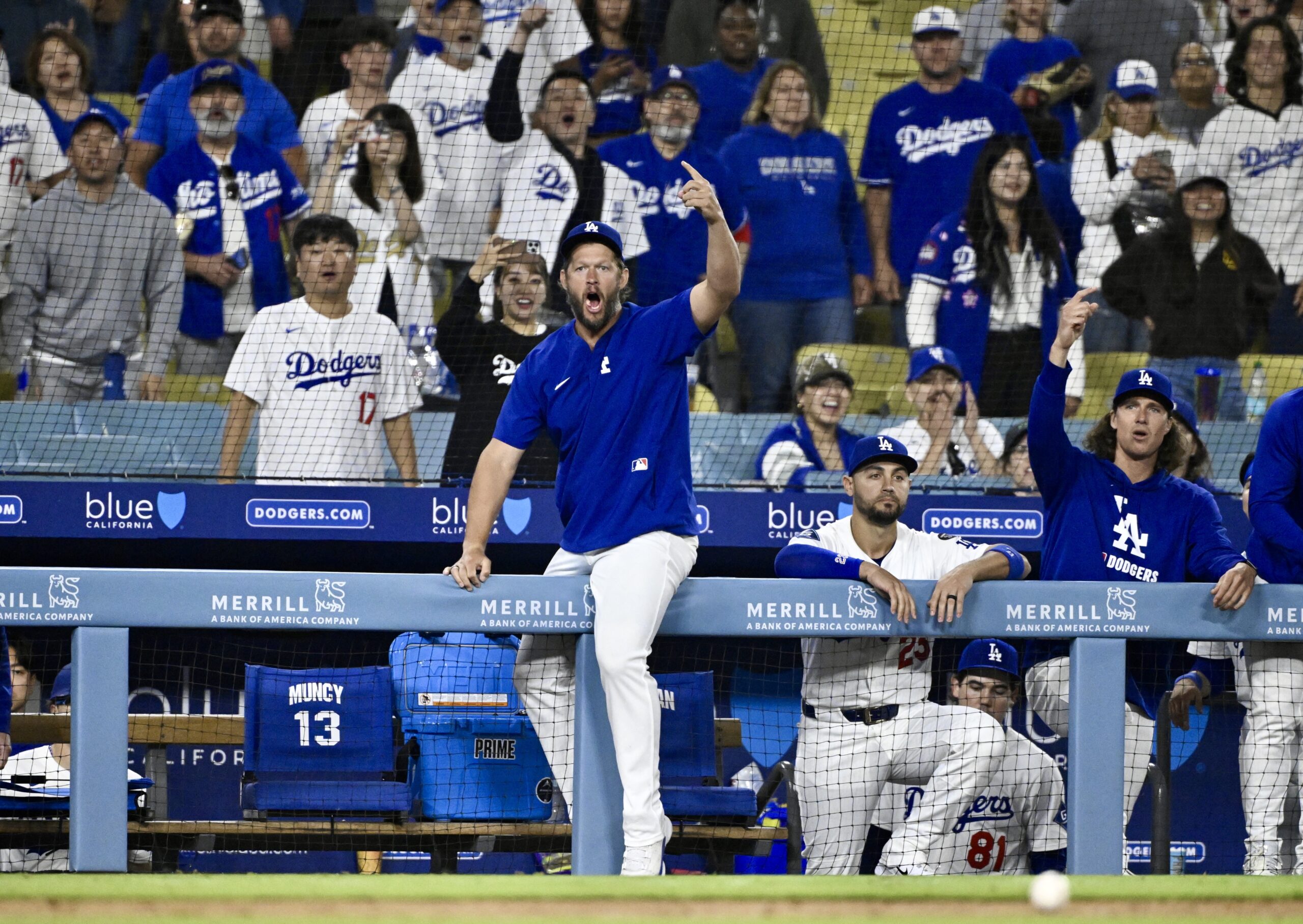 Dodgers pitcher Clayton Kershaw reacts on the dugout railing after...
