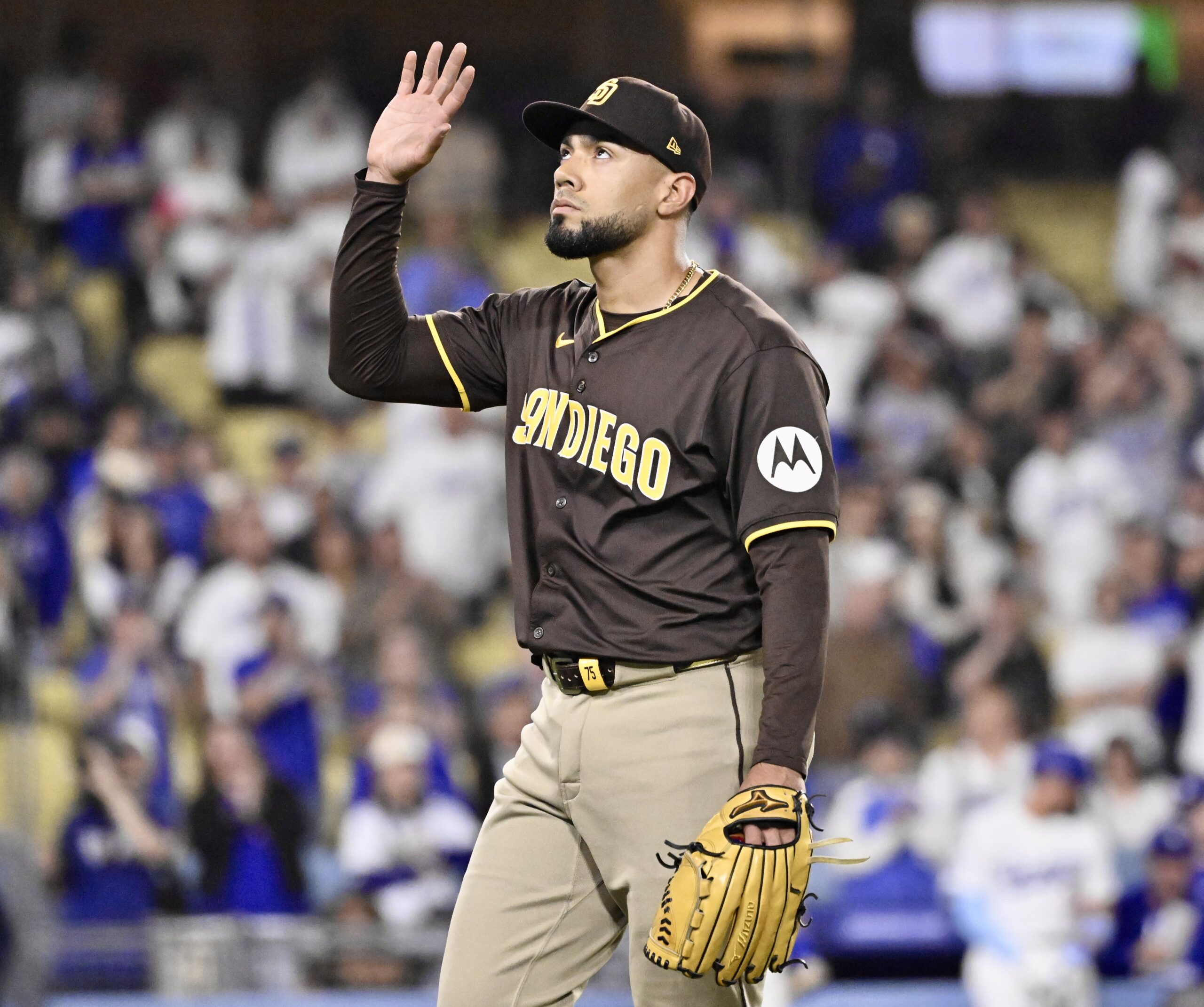 San Diego Padres relief pitcher Robert Suarez reacts after being...