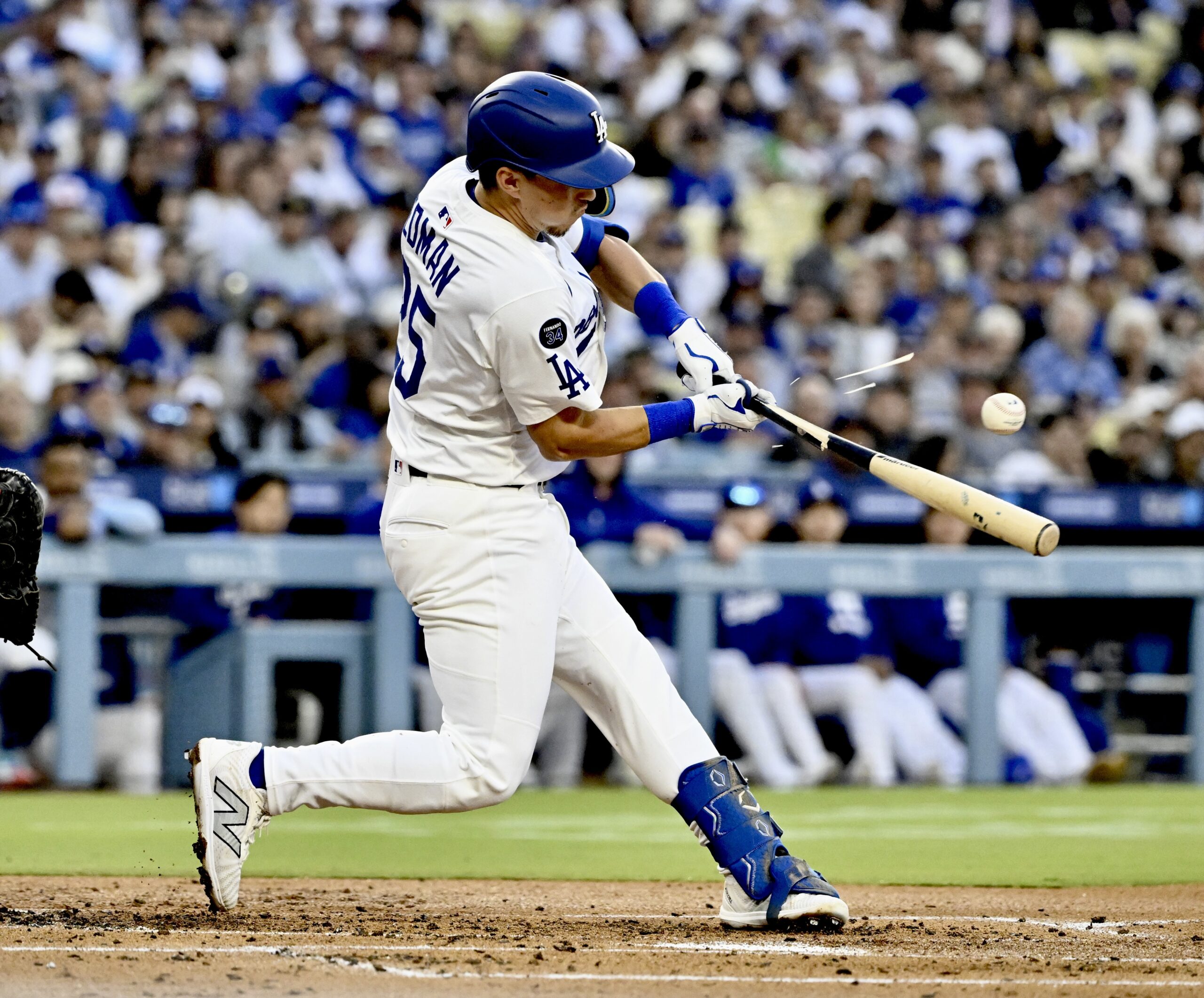 The Dodgers’ Tommy Edman breaks his bat on a pop-up...