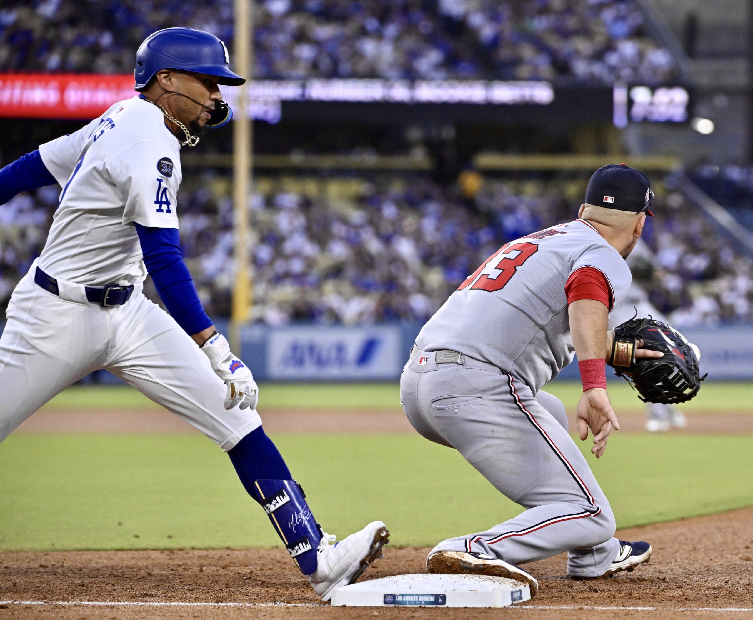 Dodgers star Mookie Betts, left, is safe at first as...