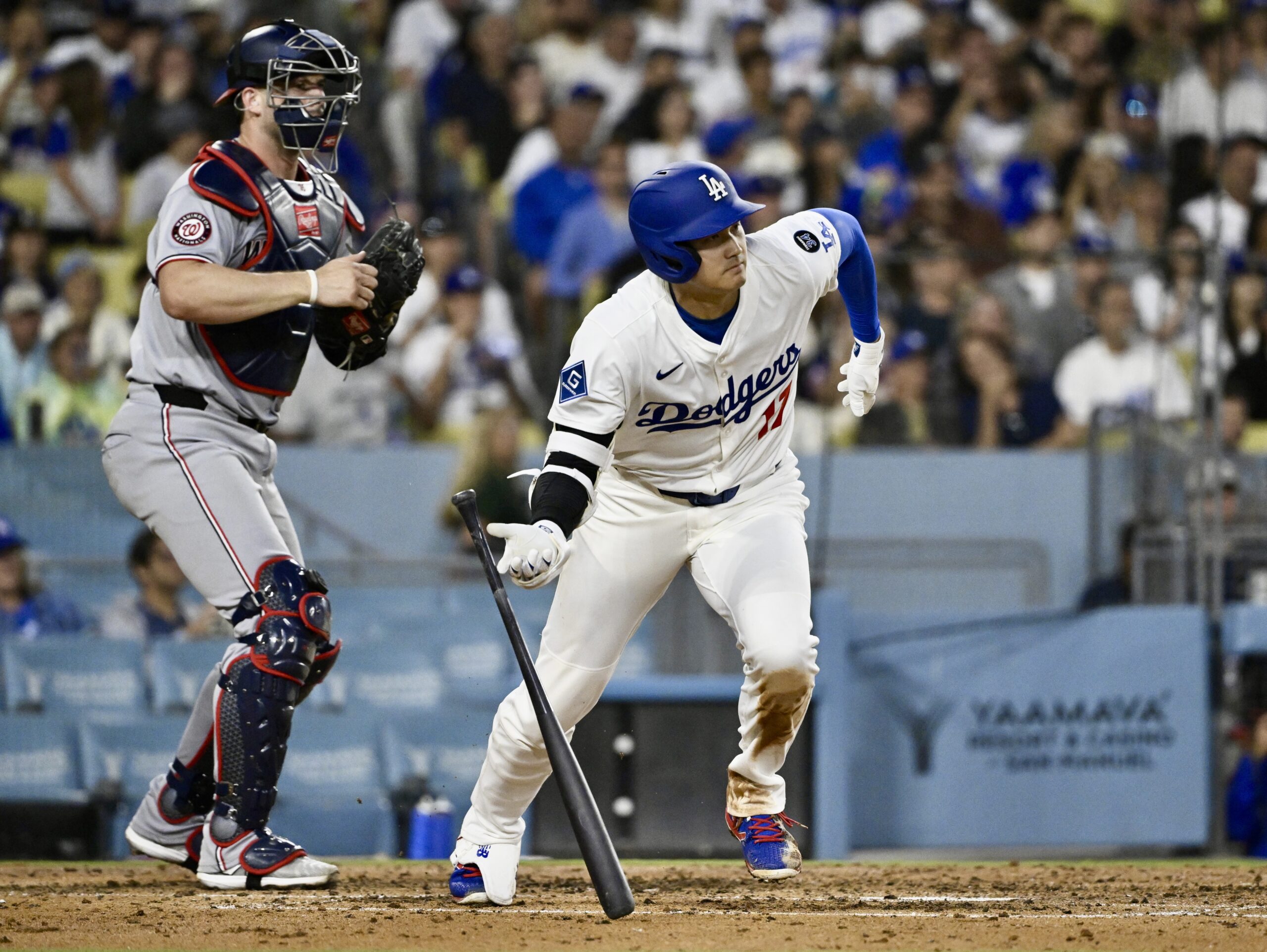 Dodgers star Shohei Ohtani begins to run after hitting an...