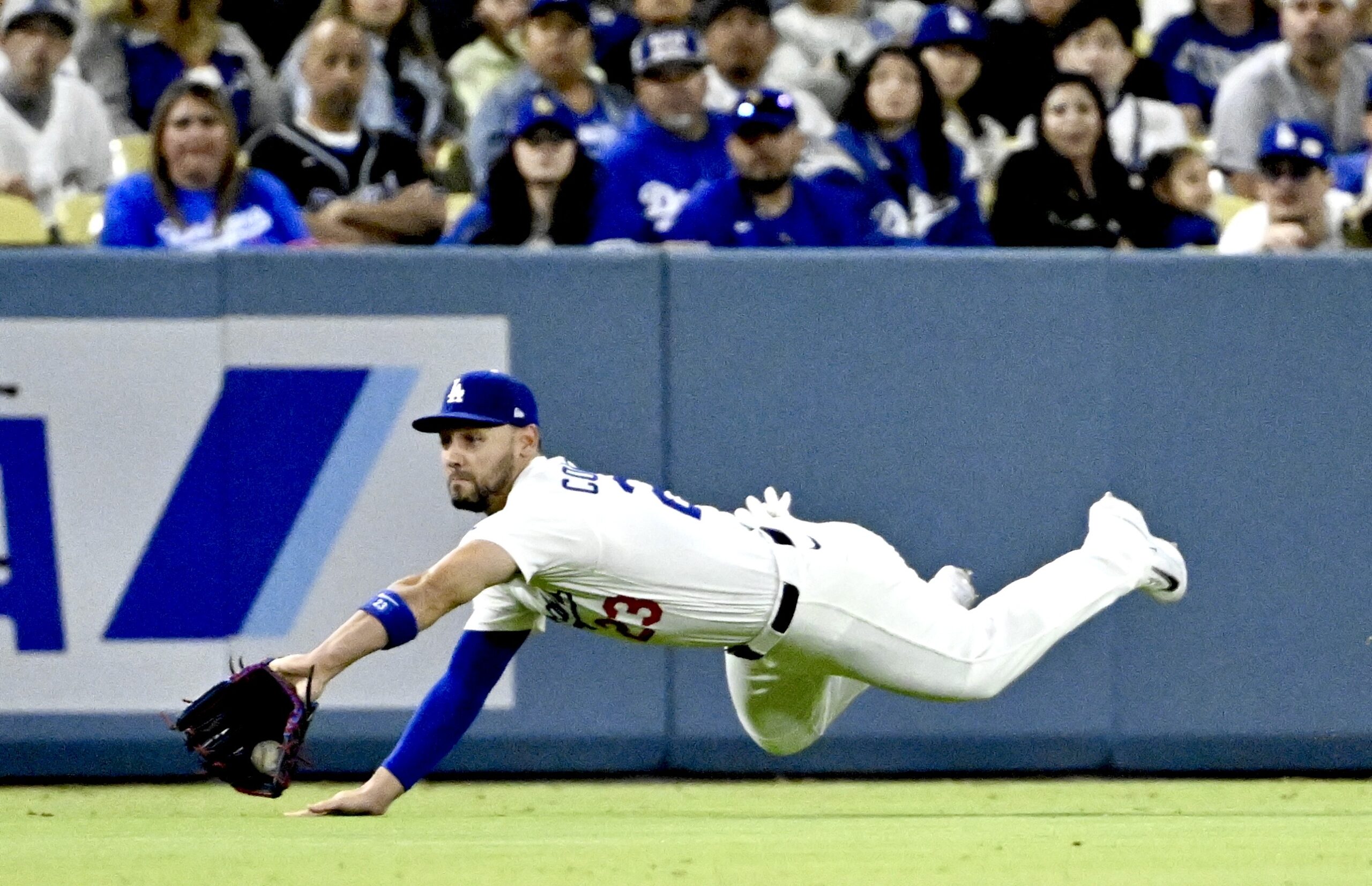 Dodgers left fielder Michael Conforto makes a diving catch on...