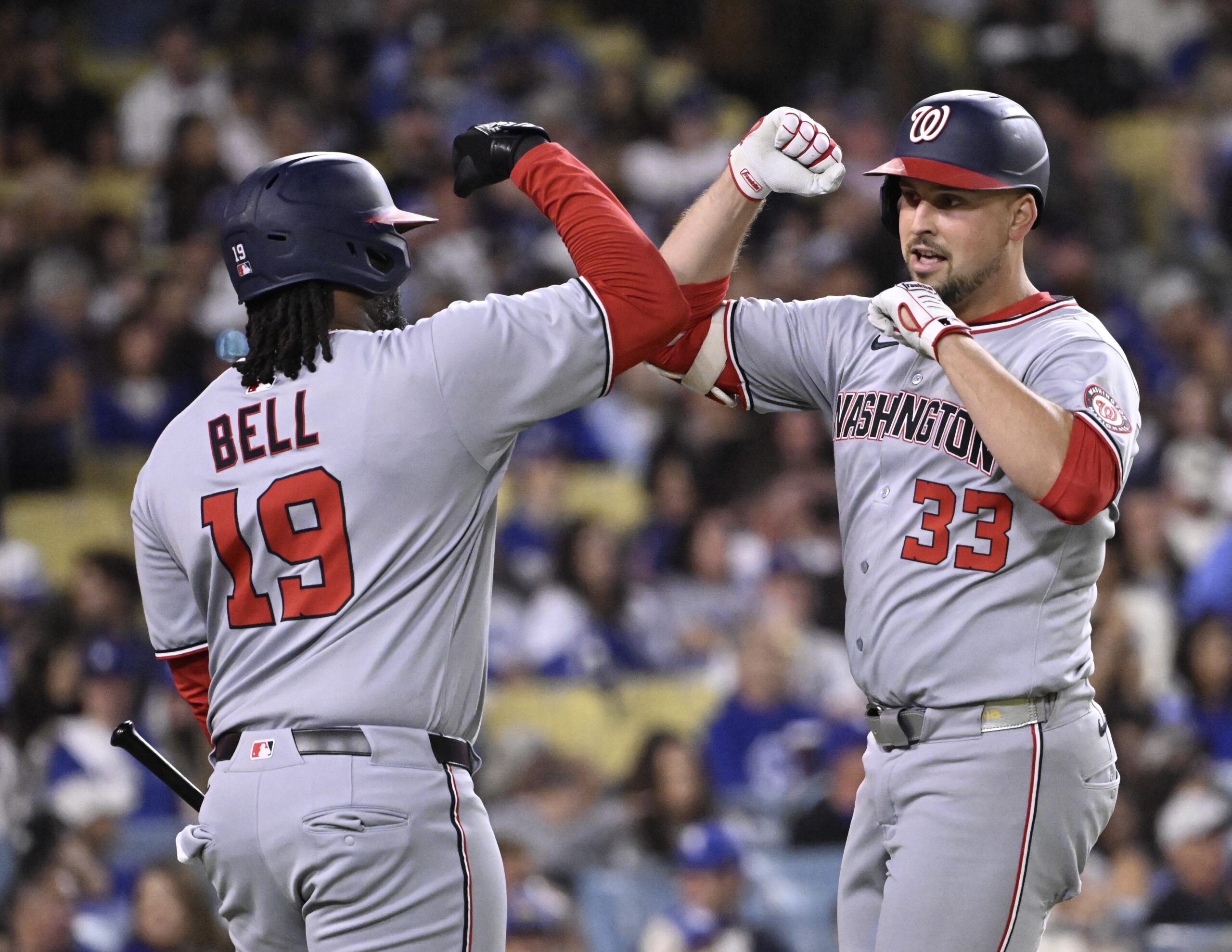 Nathaniel Lowe #33 high fives teammate Josh Bell #19 of...