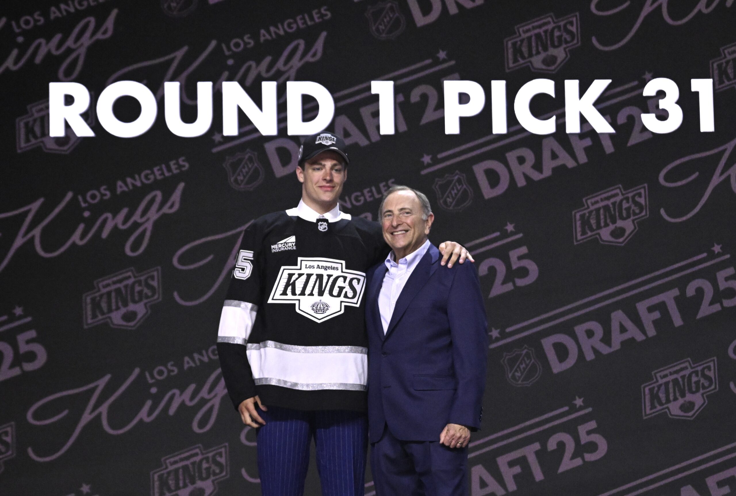 Kings first-round draft pick Henry Brzustewicz poses with NHL commissioner...