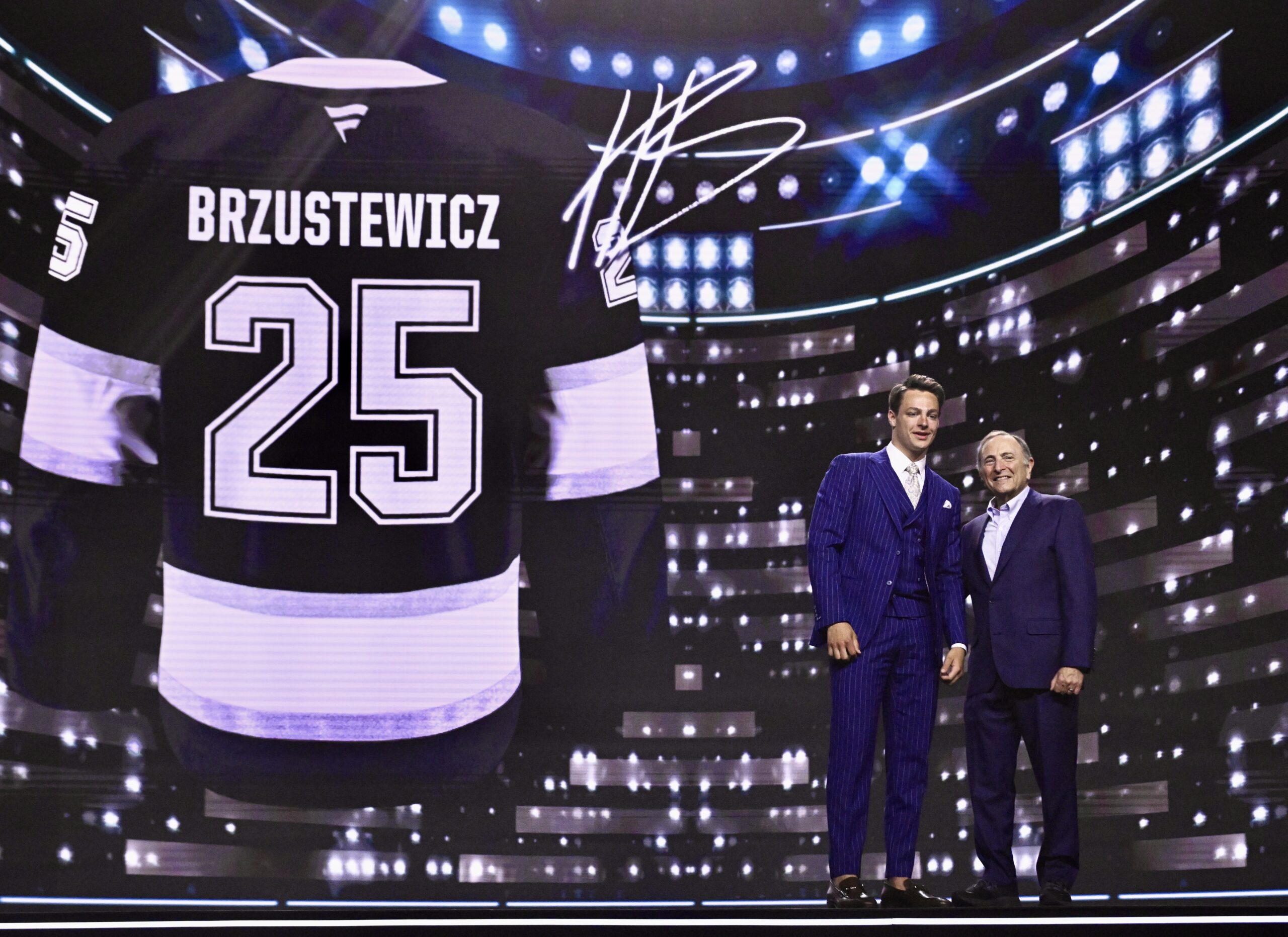 Kings first-round draft pick Henry Brzustewicz, left, poses with NHL...