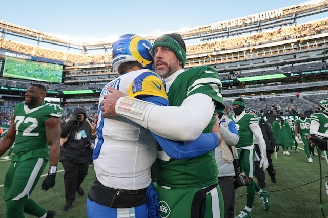 Dec 22, 2024; East Rutherford, New Jersey, USA; Los Angeles Rams quarterback Matthew Stafford (9) hits New York Jets quarterback Aaron Rodgers (8) after the game at MetLife Stadium. Mandatory Credit: Vincent Carchietta-Imagn Images Matthew Stafford, Aaron Rodgers, Jets, Rams