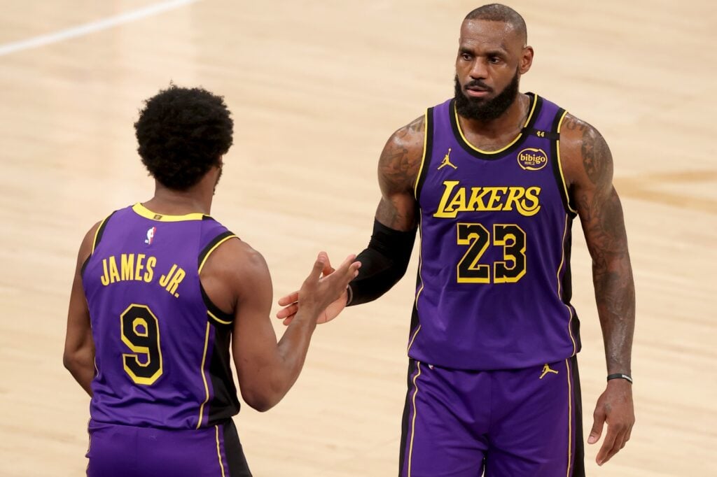 Feb 1, 2025; New York, New York, USA; Los Angeles Lakers guard Bronny James (9) checks in for forward LeBron James (23) during the fourth quarter against the New York Knicks at Madison Square Garden. Mandatory Credit: Brad Penner-Imagn Images